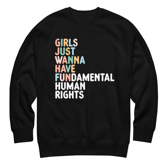 Black unisex premium sweatshirt featuring stacked multicolor typography reading “Girls Just Wanna Have Fundamental Human Rights,” feminist activist sweatshirt from Blue Wave USA.