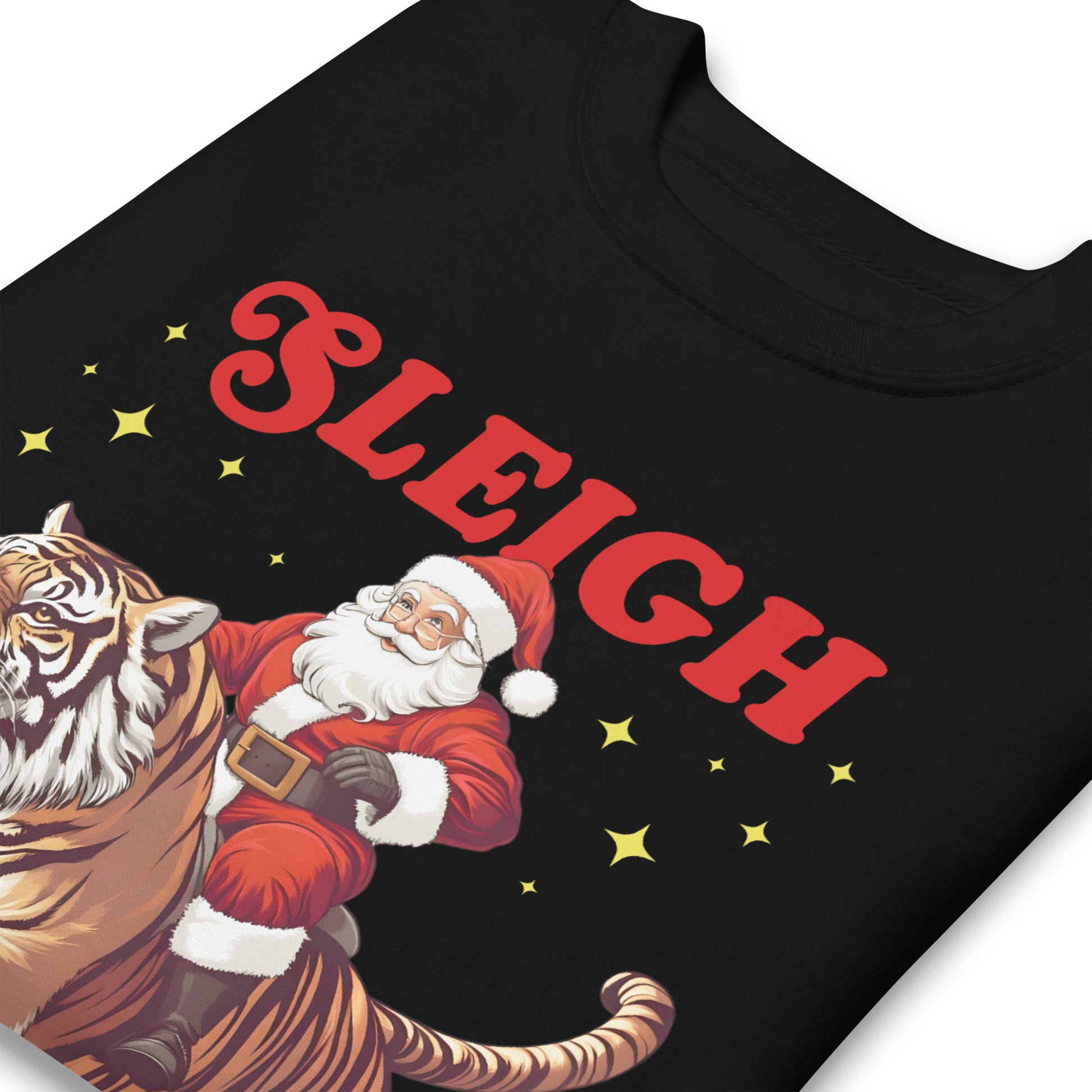 Close-up view of the “Sleigh the Patriarchy” sweatshirt graphic showing Santa on a tiger with red lettering and gold stars.
