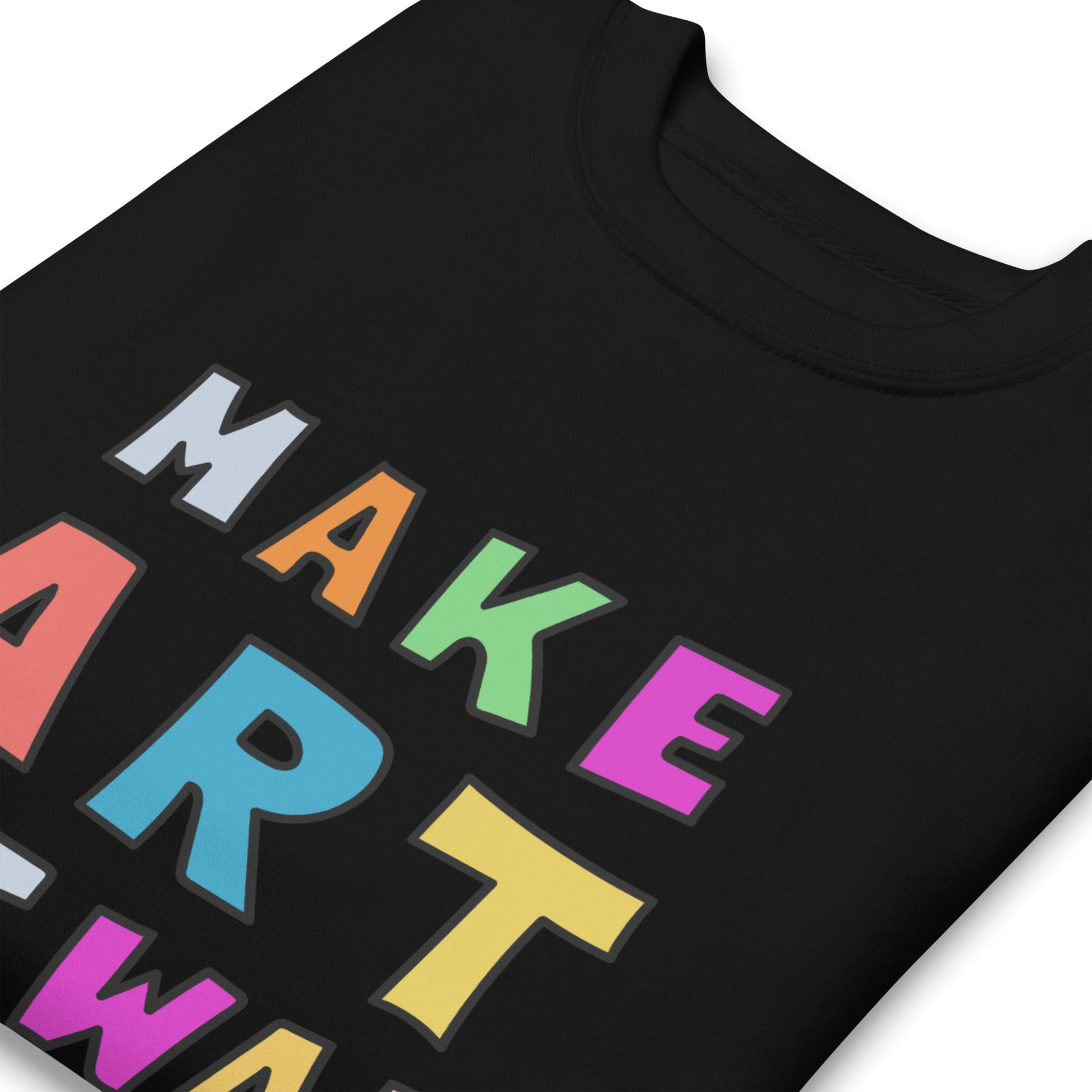 Close-up of multicolor block lettering on a black unisex premium sweatshirt, highlighting smooth fabric texture and crisp print details spelling “MAKE ART NOT WAR,” from Blue Wave USA.
