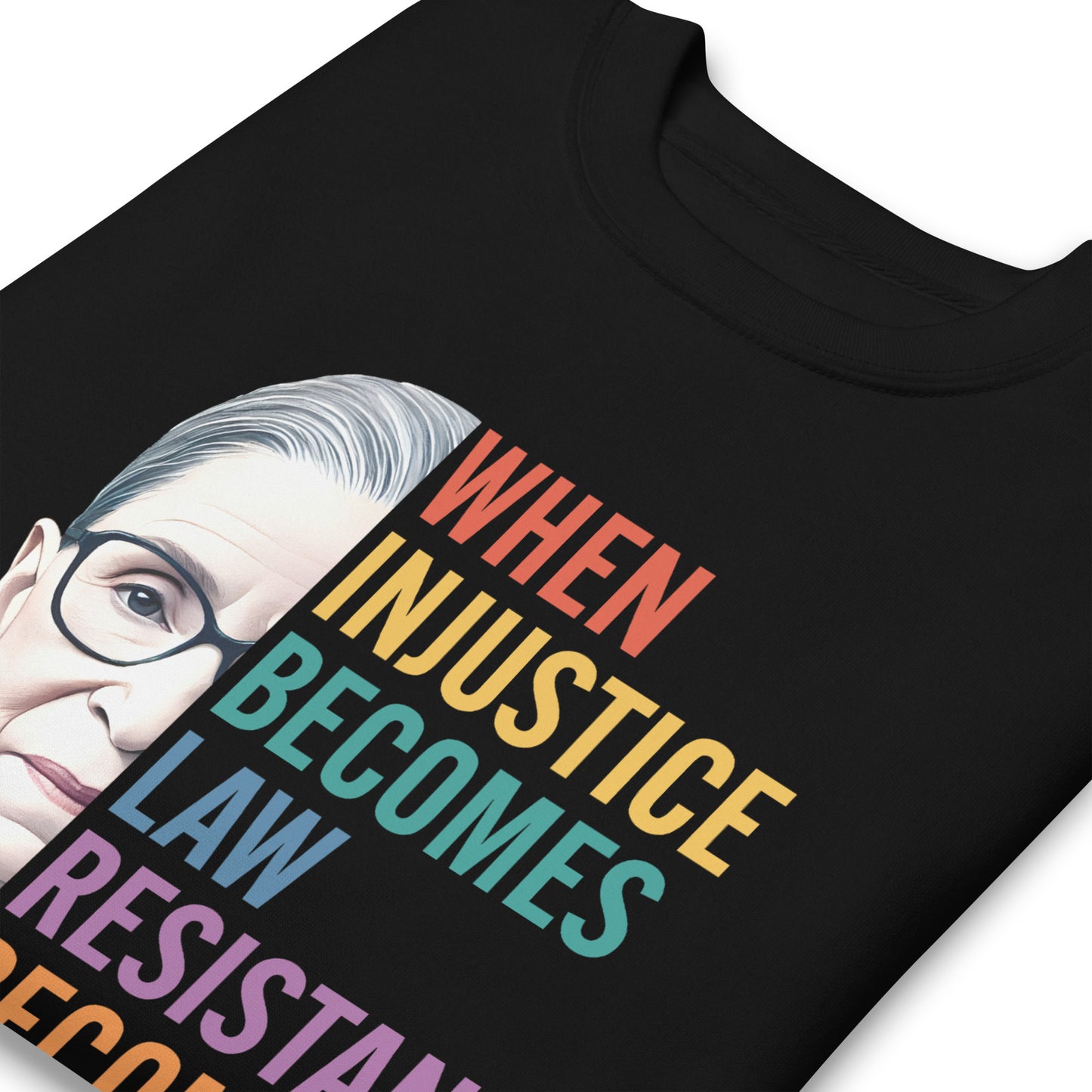 Close-up of black unisex premium sweatshirt showing Ruth Bader Ginsburg portrait and rainbow typography, progressive activist apparel from Blue Wave USA.