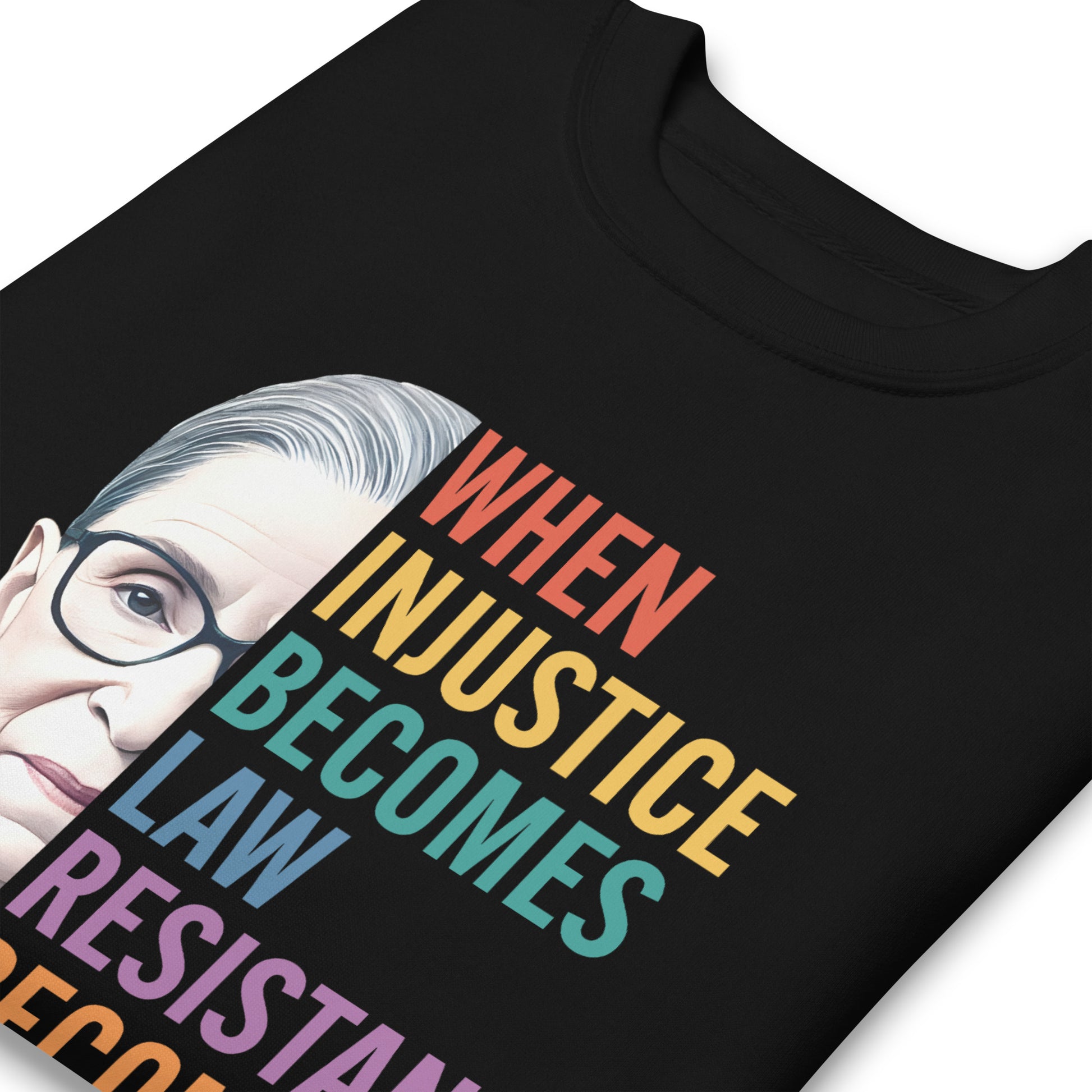 Close-up of black unisex premium sweatshirt showing Ruth Bader Ginsburg portrait and rainbow typography, progressive activist apparel from Blue Wave USA.