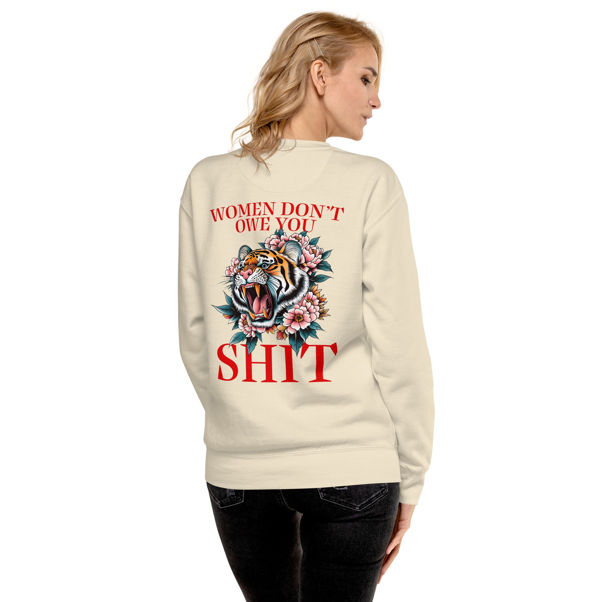 Sand unisex premium sweatshirt worn from back featuring roaring tiger illustration and phrase “Women Don’t Owe You Sh*t,” women’s rights activist clothing.