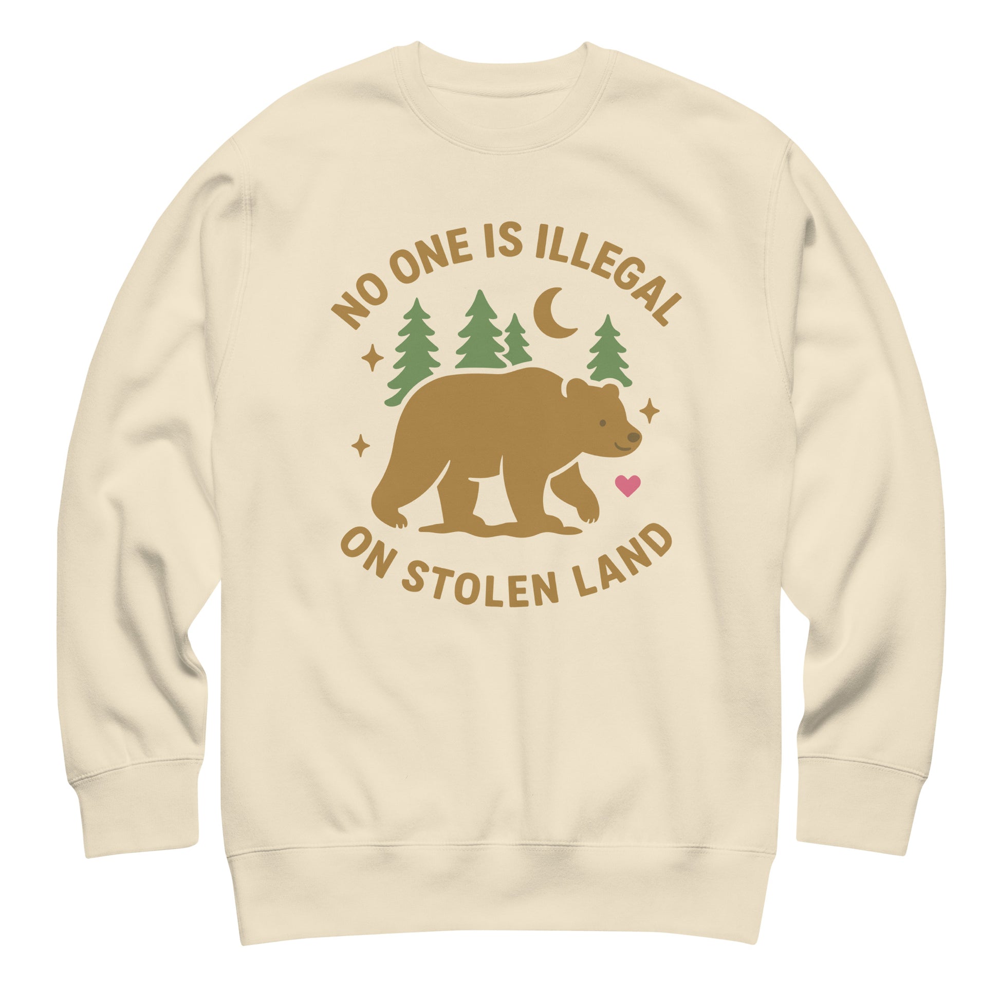 Sand unisex premium sweatshirt showing the bear, pine trees, moon, and heart illustration paired with the message “NO ONE IS ILLEGAL ON STOLEN LAND,” printed in earthy natural tones.