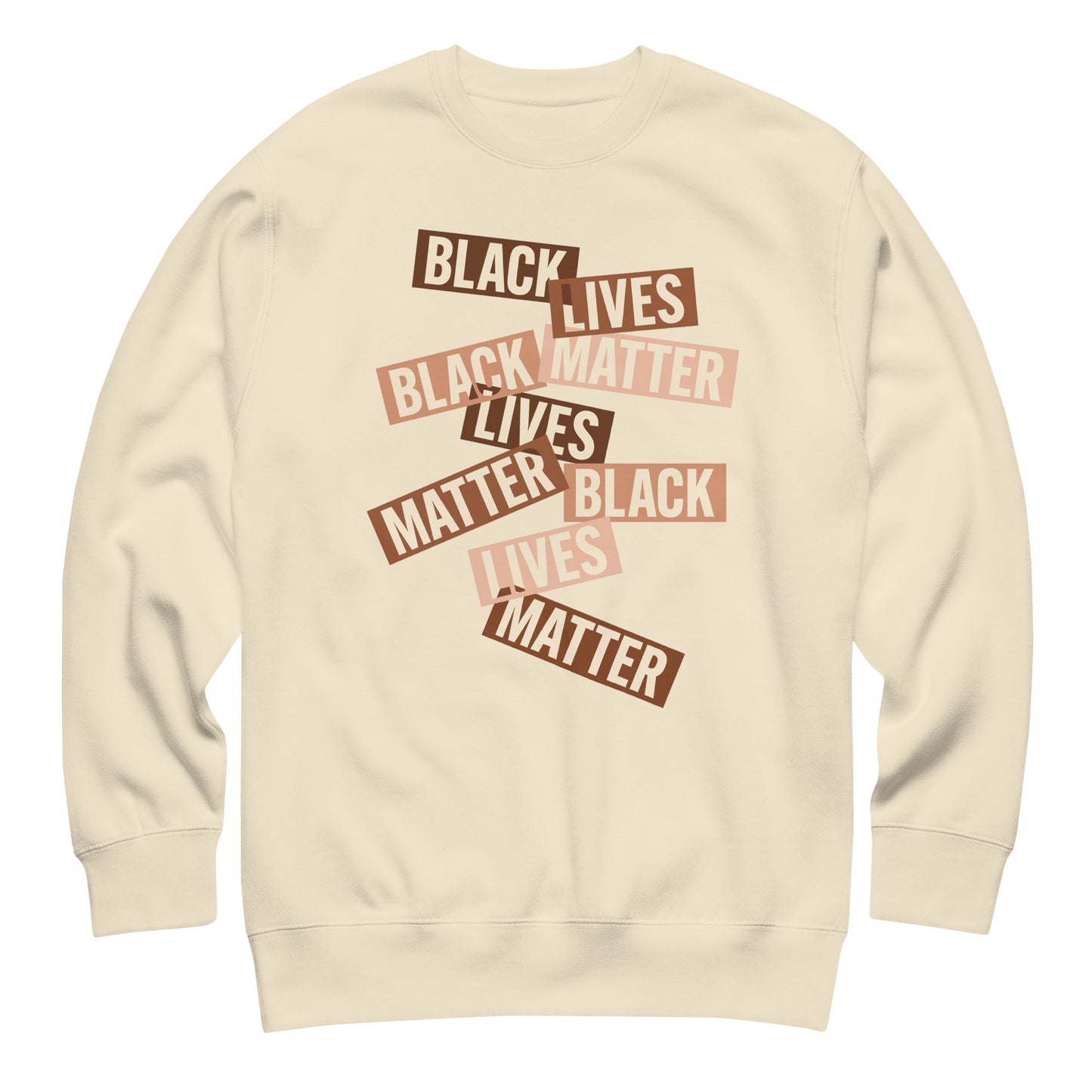 Cream sweatshirt showing layered brown cut-paper strips reading “BLACK LIVES MATTER.” A warm, soft-toned activist message.