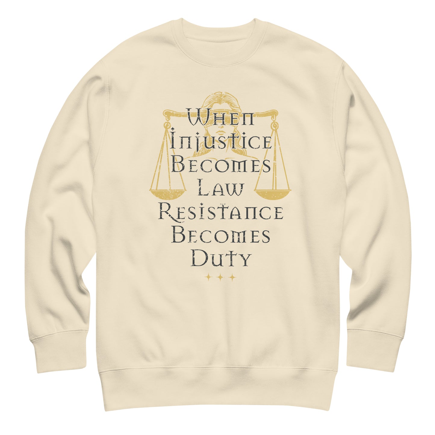Cream unisex premium sweatshirt featuring Lady Justice scales illustration with gold typography, centered progressive justice graphic.