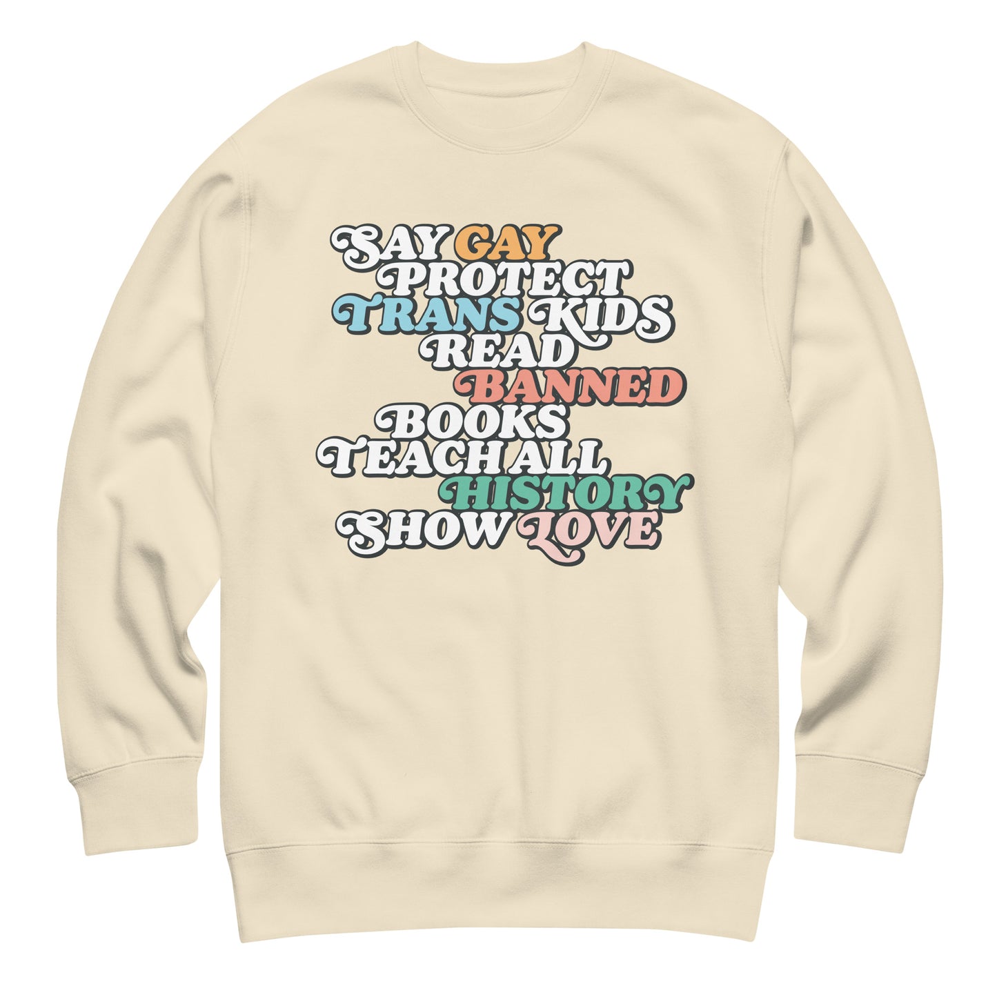 Sand-colored unisex premium sweatshirt featuring retro stacked typography reading “Say Gay Protect Trans Kids Read Banned Books Teach All History Show Love,” justice-focused apparel from Blue Wave USA.