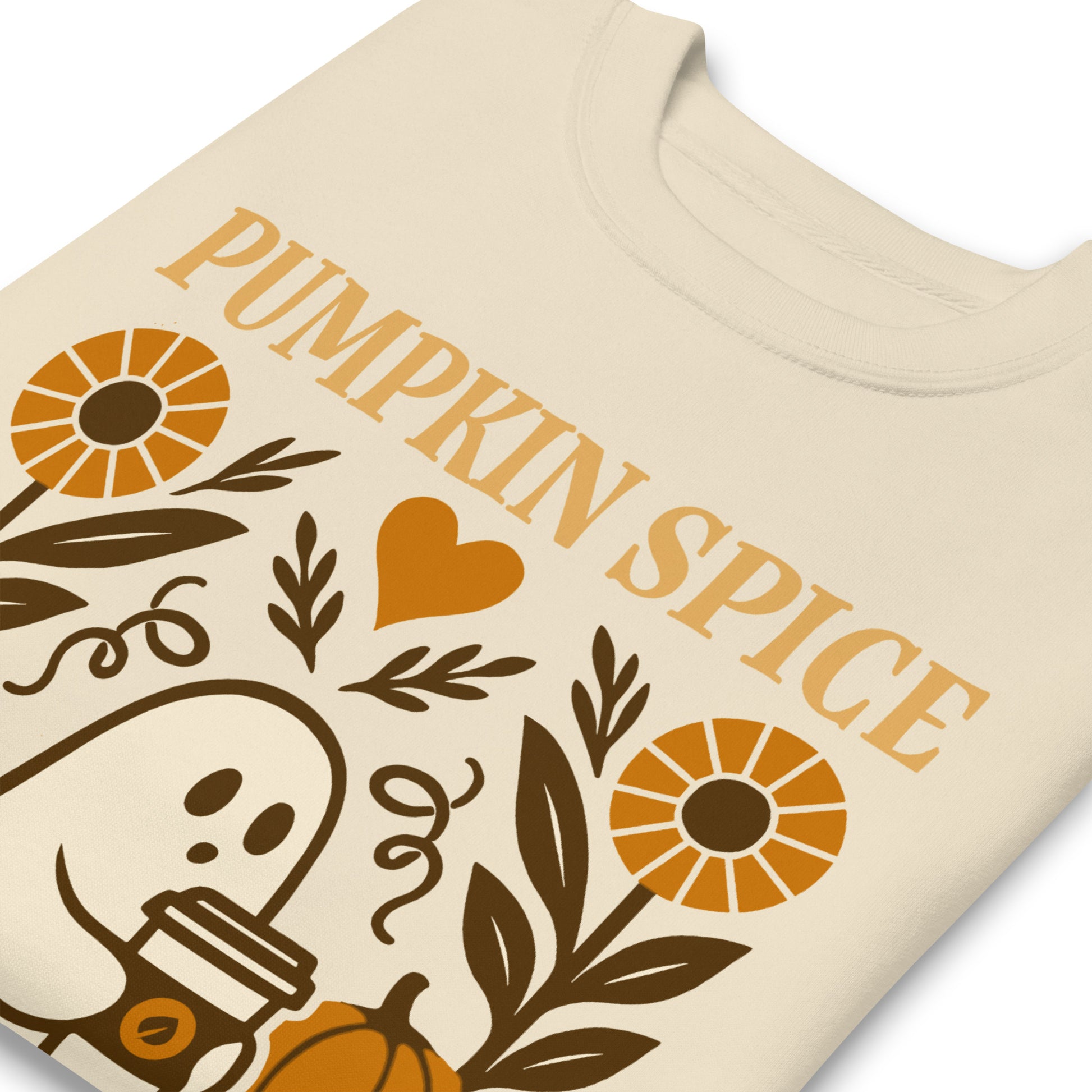 Close-up of “Pumpkin Spice & Human Rights” ghost and floral print on soft cream sweatshirt, warm seasonal graphic detail.