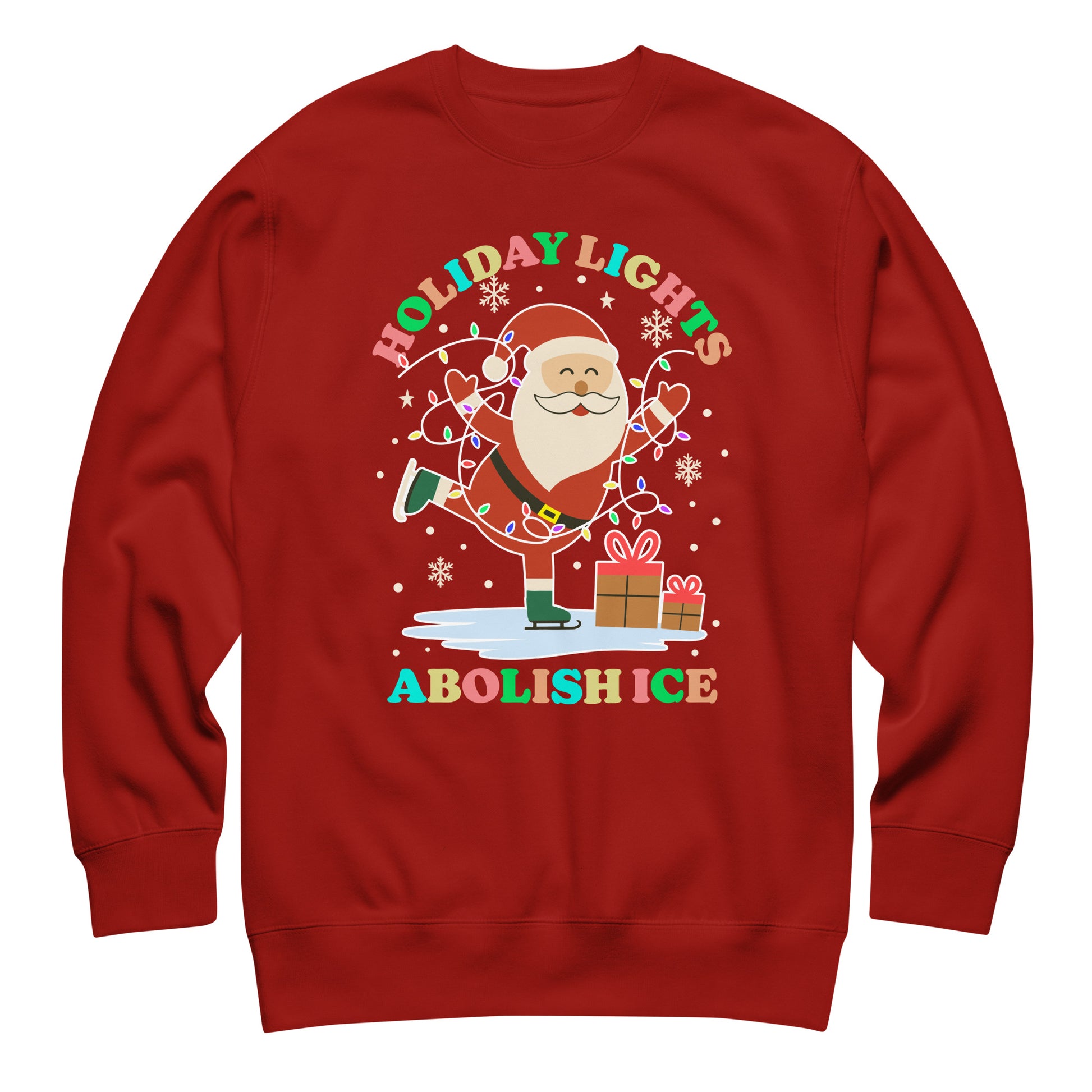 A red unisex sweatshirt showing Santa, twinkling lights, stars, and snowflakes arranged around the message “HOLIDAY LIGHTS ABOLISH ICE,” bringing playful progressive spirit to holiday wear.