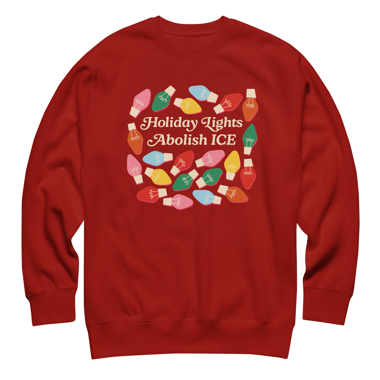 A red unisex sweatshirt featuring playful holiday bulbs surrounding “Holiday Lights Abolish ICE,” styled in a simple flat lay to emphasize its warm seasonal advocacy theme.