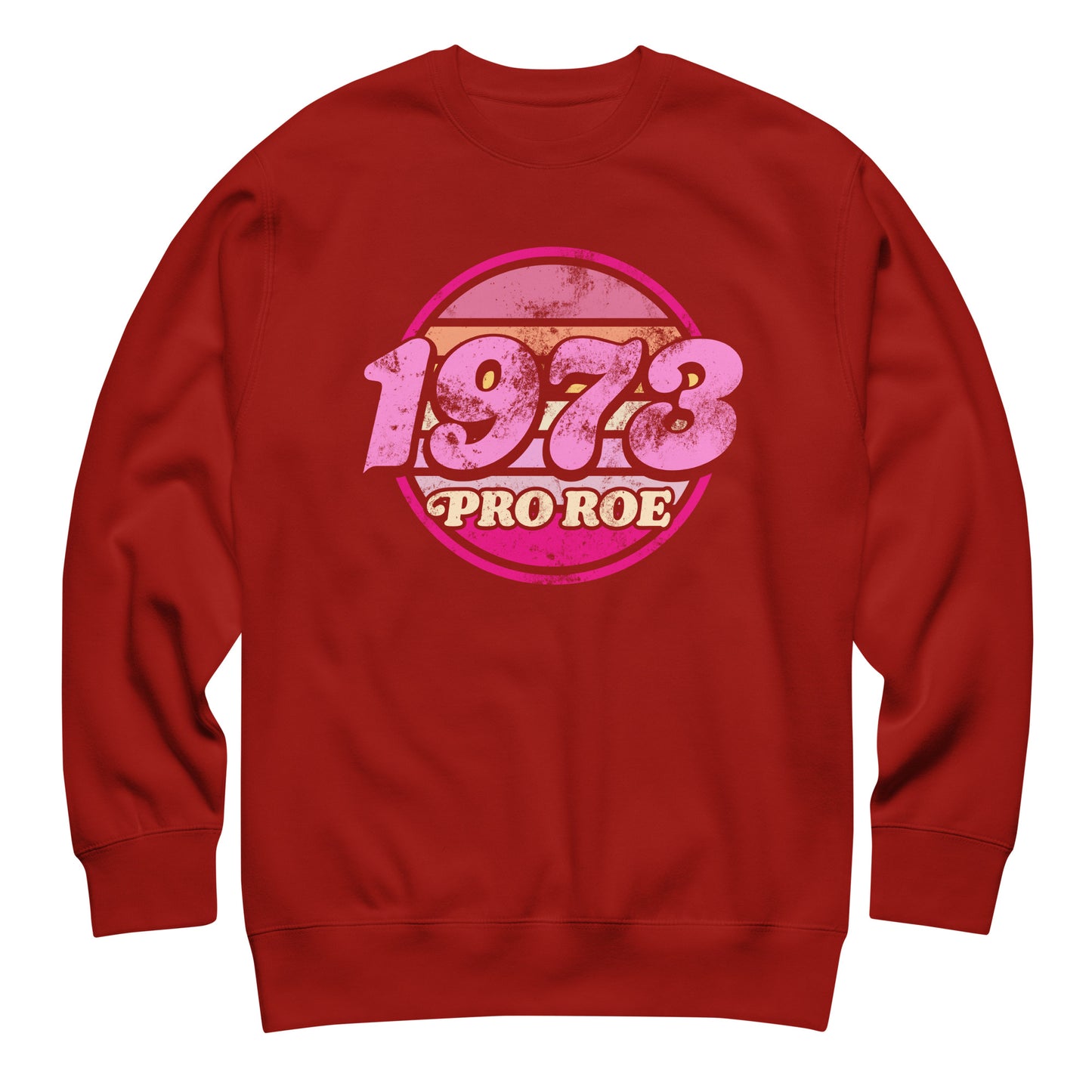 Cardinal red unisex premium sweatshirt displayed flat, showcasing the distressed circular “1973 PRO ROE” graphic in pink tones, bold vintage activist design on warm red fabric.