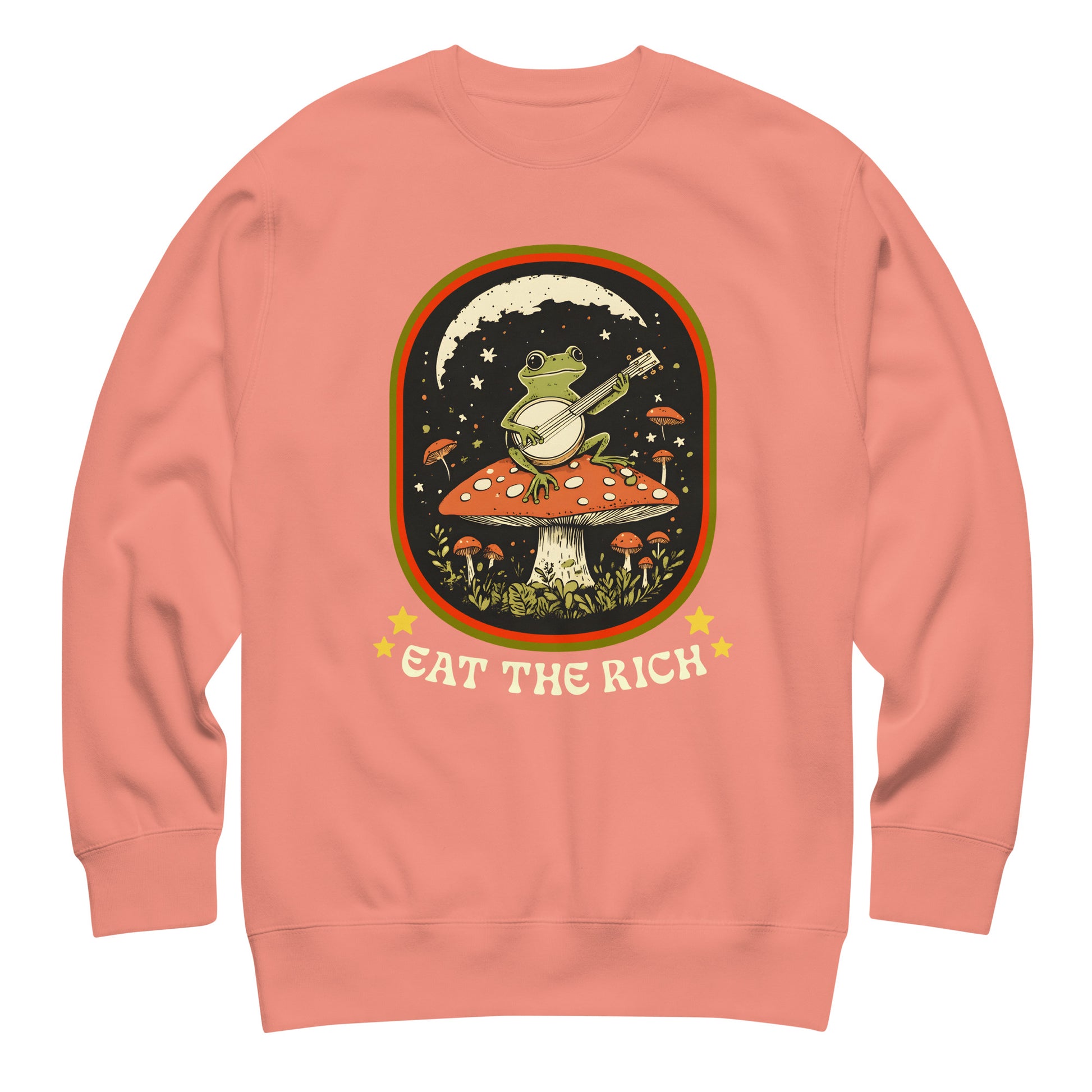 Coral unisex premium sweatshirt featuring illustrated frog banjo scene with bold “Eat The Rich” protest message.
