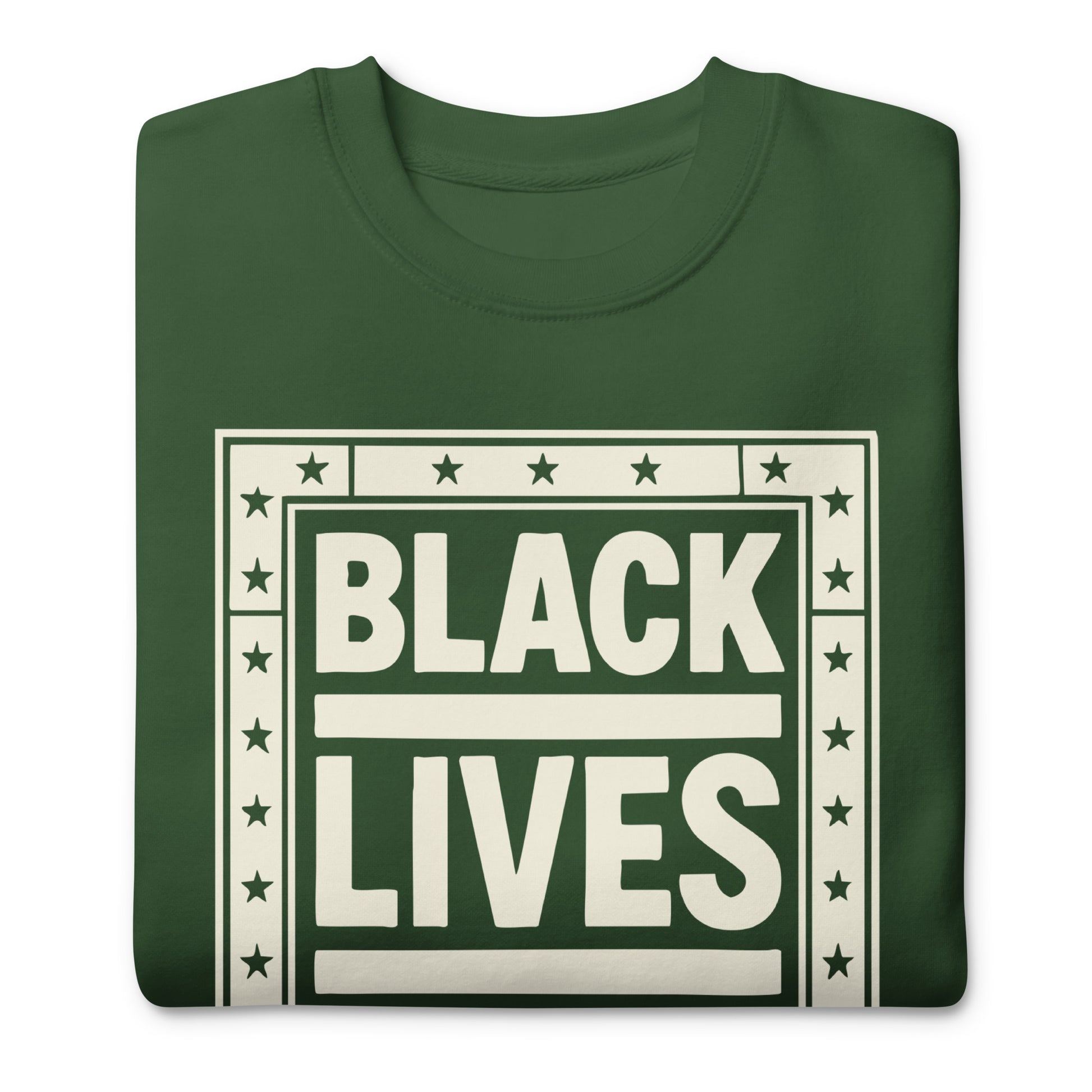 Close-up of a forest-green unisex sweatshirt showing the framed cream “BLACK LIVES MATTER” block-print design, crisp edges, and star details.