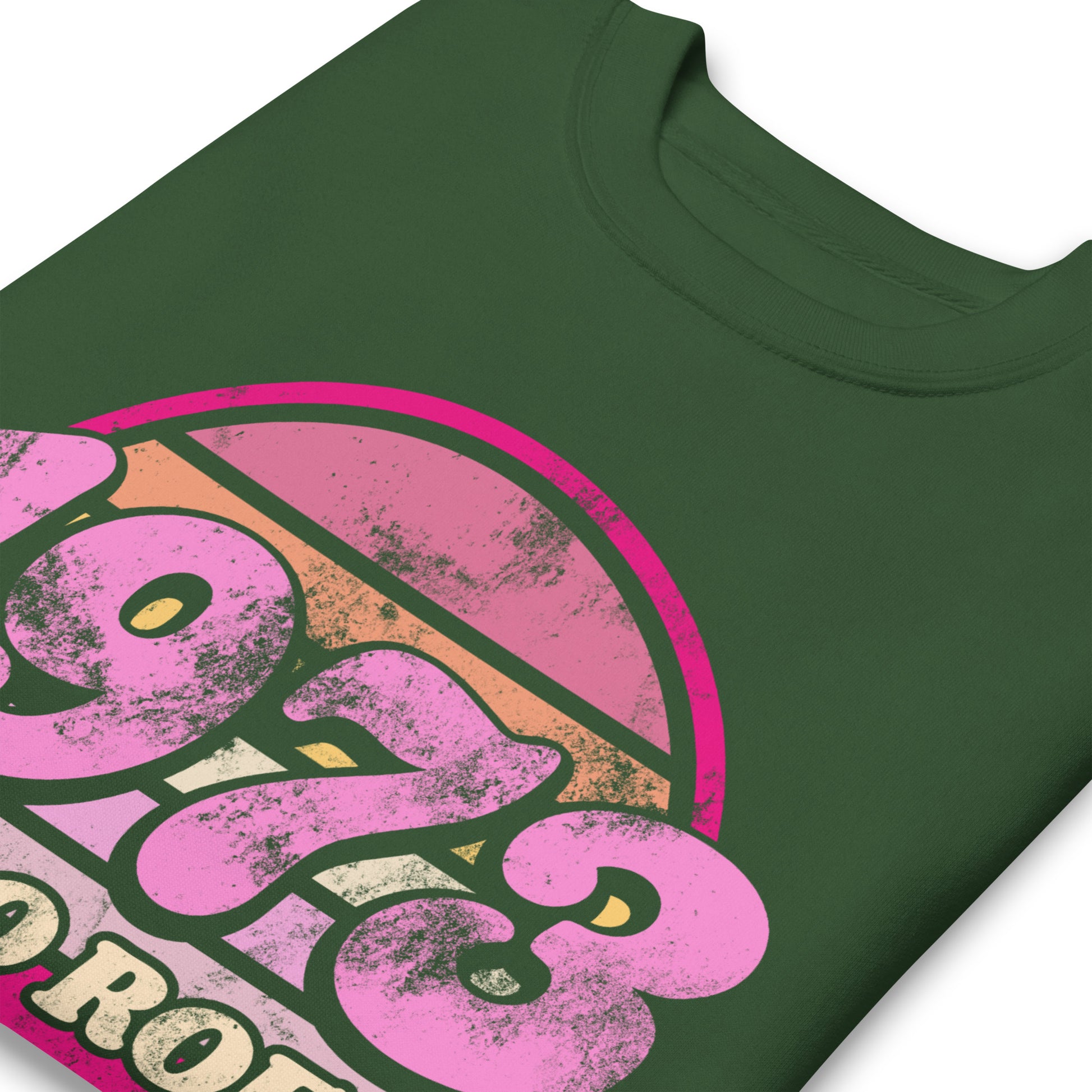 Close-up of the vintage print on a forest green unisex premium sweatshirt, highlighting distressed pink textures, rounded lettering, and the circular “1973 PRO ROE” emblem from Blue Wave USA.