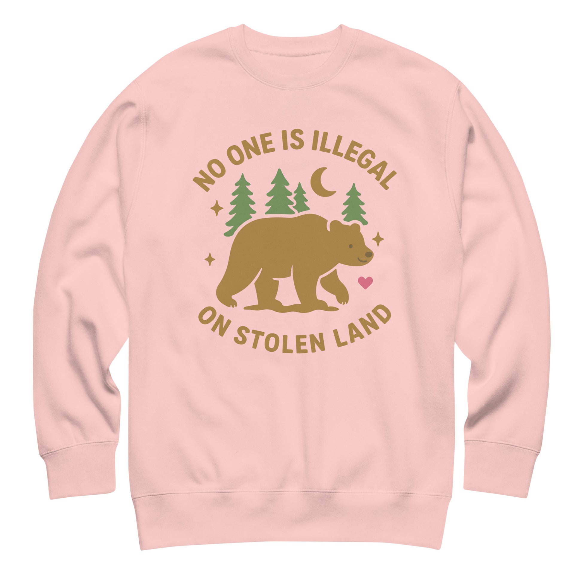 Light pink unisex premium sweatshirt featuring the tan bear, trees, moon, and stars with the printed message “NO ONE IS ILLEGAL ON STOLEN LAND,” a soft activist design.
