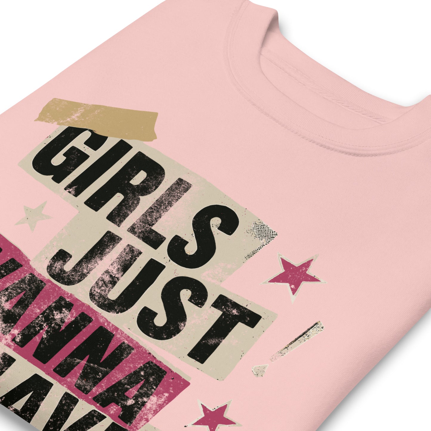 Close-up of pink sweatshirt showing distressed collage typography and star accents. Feminist punk-inspired sweatshirt design with bold vintage textures.