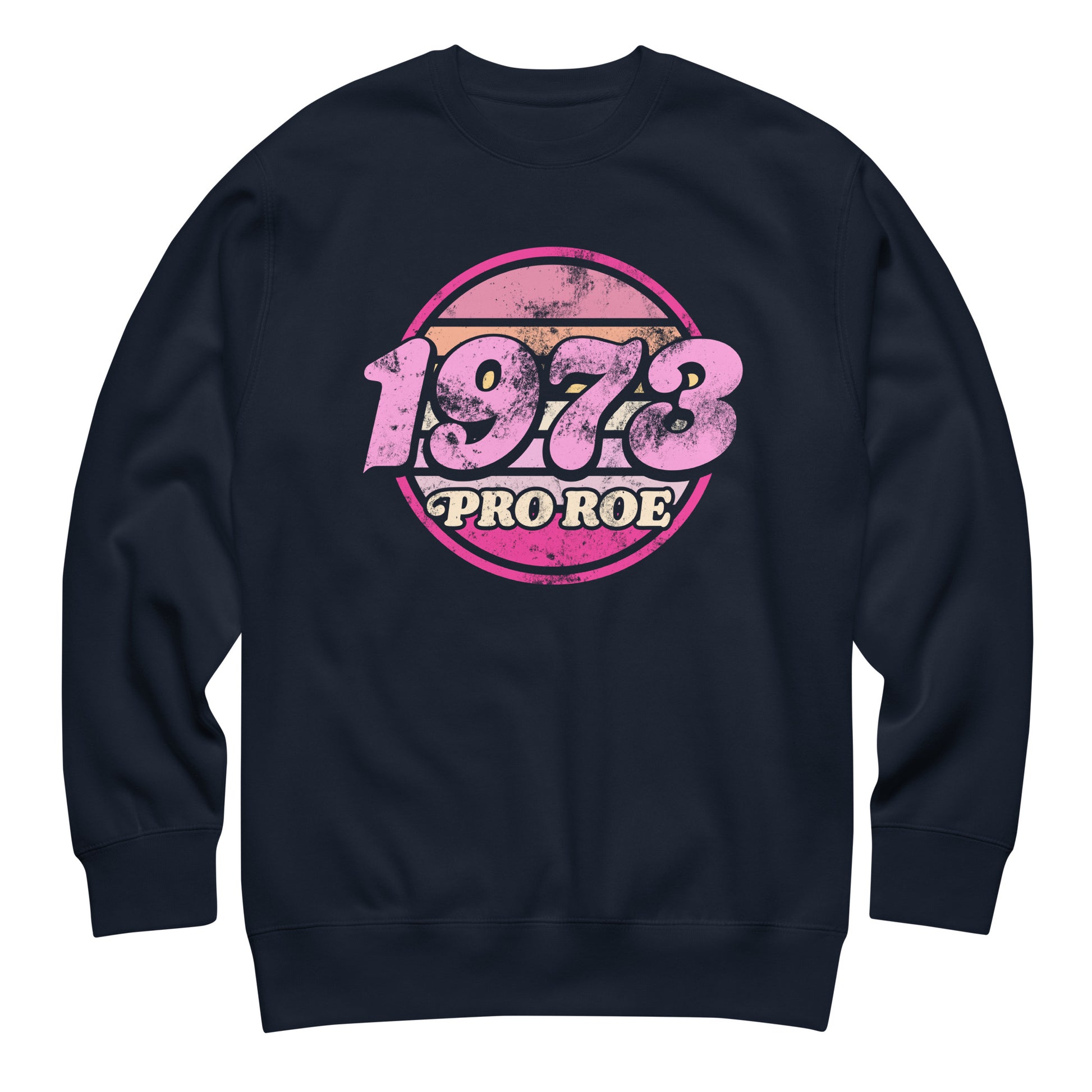 Navy unisex premium sweatshirt shown front-facing, featuring a faded pink circular badge reading “1973 PRO ROE,” classic retro reproductive freedom design centered on dark fleece.