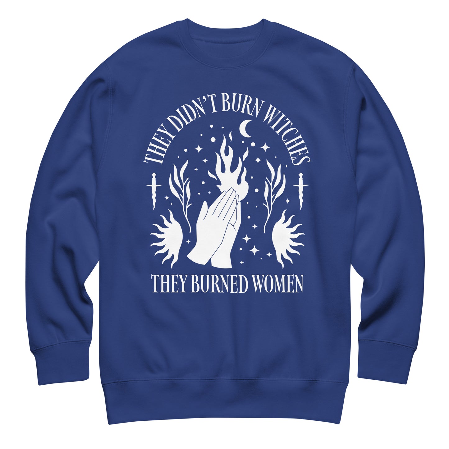 Royal blue unisex premium sweatshirt with high-contrast white illustration of flames and celestial symbols, balanced centered design, printed message “THEY DIDN’T BURN WITCHES THEY BURNED WOMEN.”