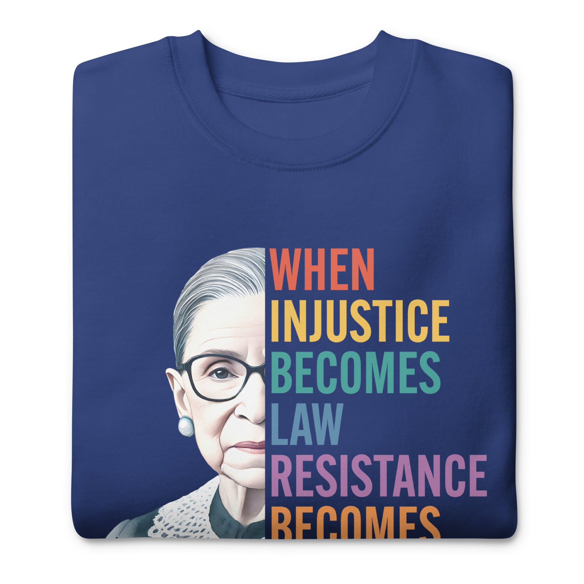 Folded blue unisex premium sweatshirt featuring Ruth Bader Ginsburg portrait with rainbow stacked typography, social justice apparel.