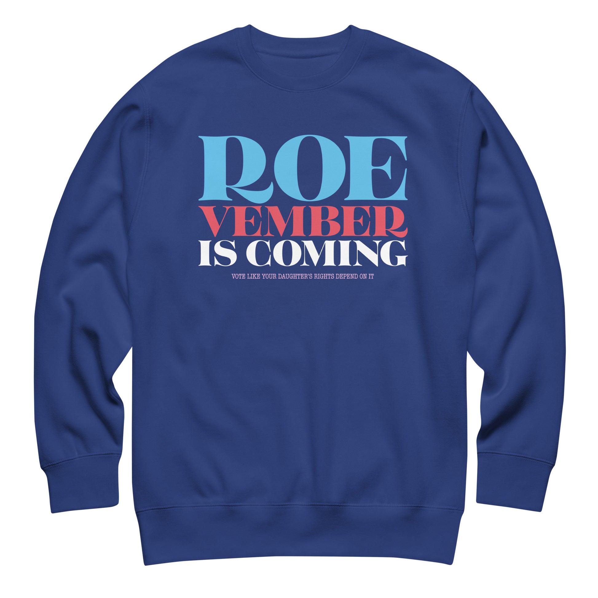 Royal blue unisex premium sweatshirt featuring bold red, white, and blue typography reading “Roevember Is Coming,” reproductive rights sweatshirt from Blue Wave USA.