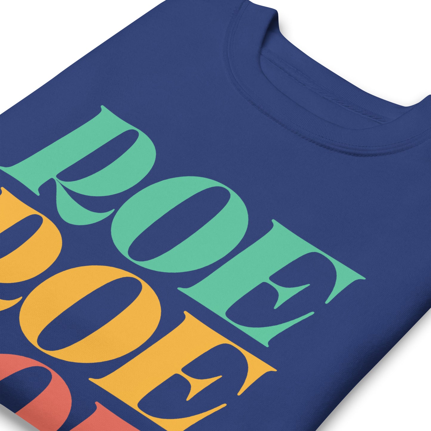 Royal blue unisex premium sweatshirt close-up featuring stacked rainbow typography reading “Roe Roe Roe Your Vote,” pro-choice apparel.