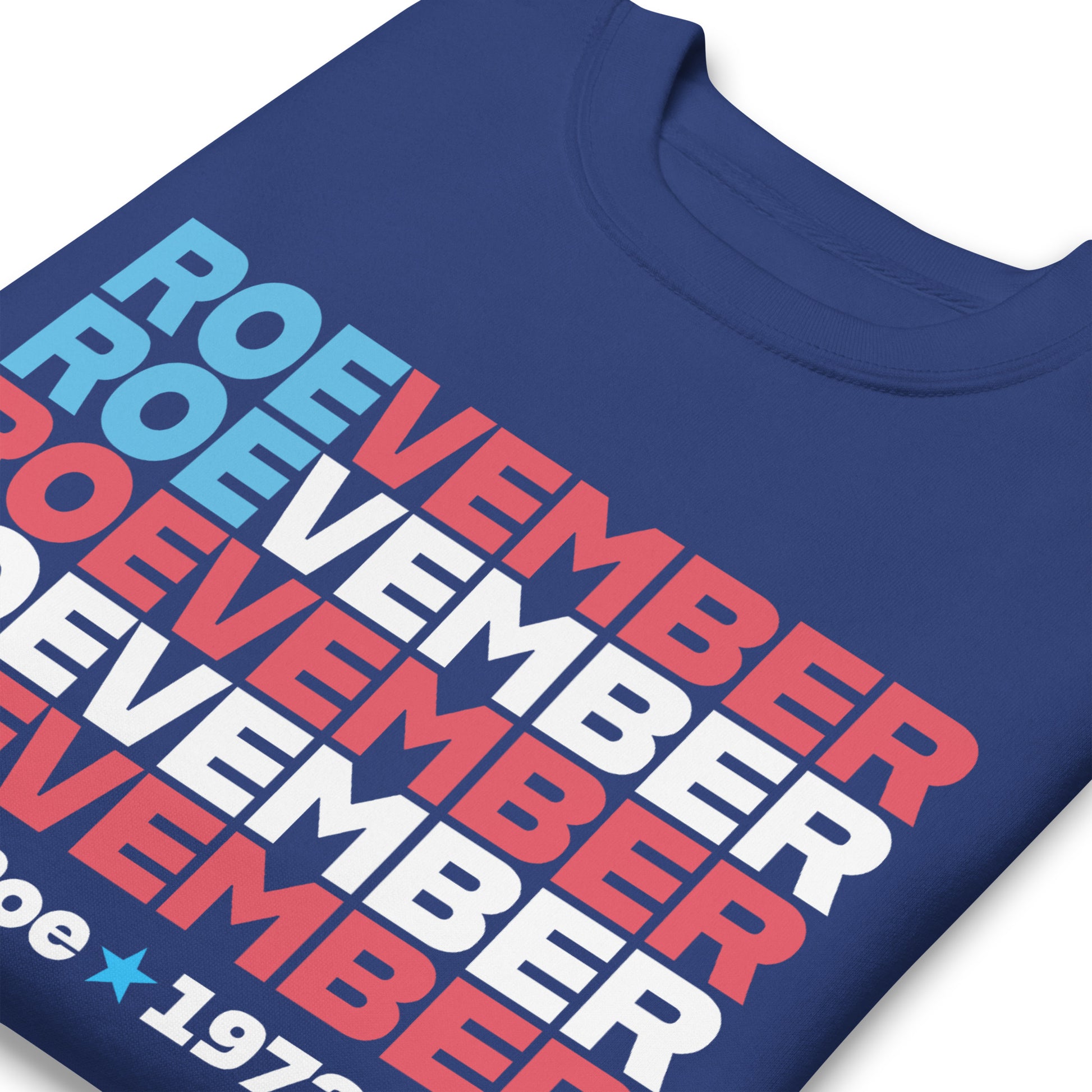 Royal blue unisex premium sweatshirt close-up featuring stacked typography reading “Roevember Pro Roe 1973.”