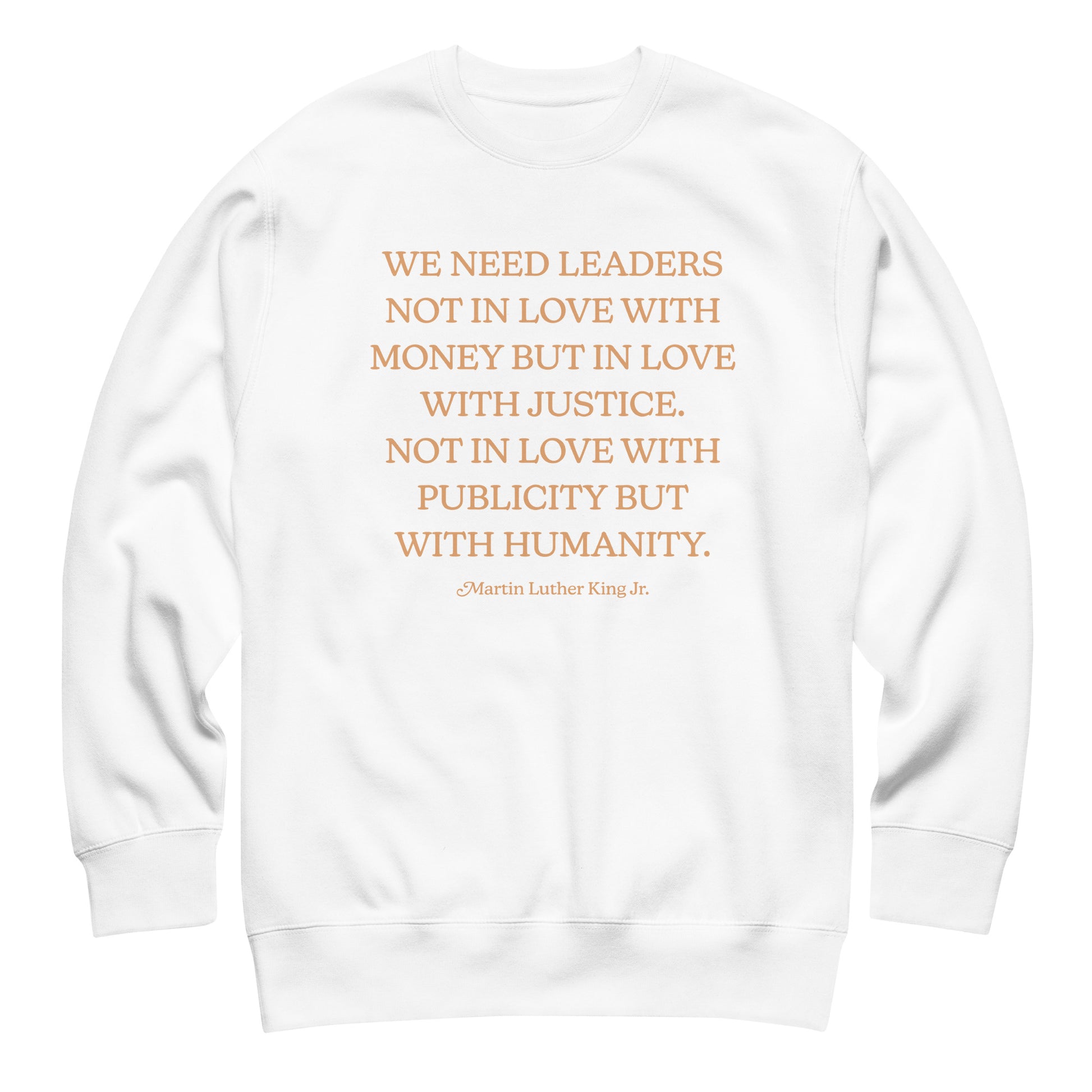White unisex premium sweatshirt with the full MLK quote arranged in gold text, promoting justice-driven leadership and public compassion.
