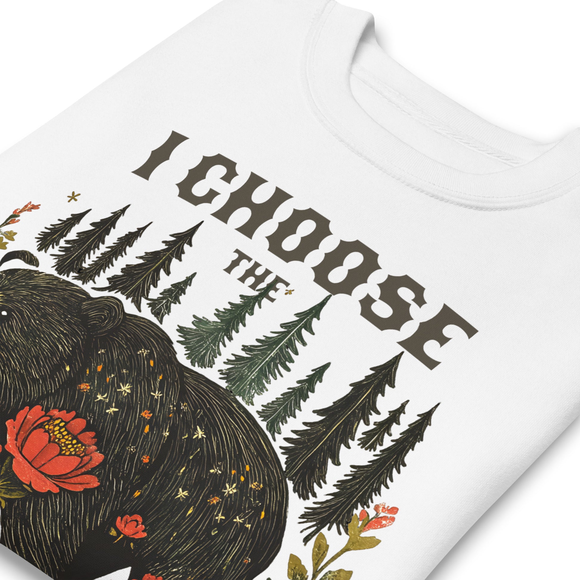 White unisex premium sweatshirt close-up featuring bear illustration with forest backdrop and phrase “I Choose The Bear,” feminist statement design.