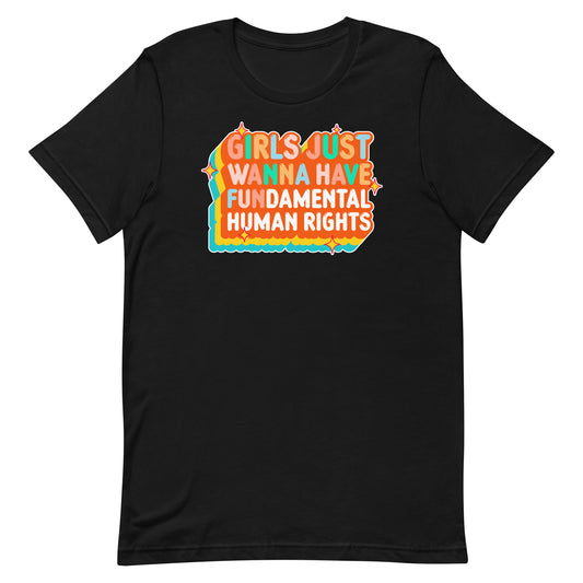 Black unisex t-shirt featuring retro orange and teal text reading “Girls Just Wanna Have Fundamental Human Rights.” Bold vintage-inspired feminist design with sunset-style layers.