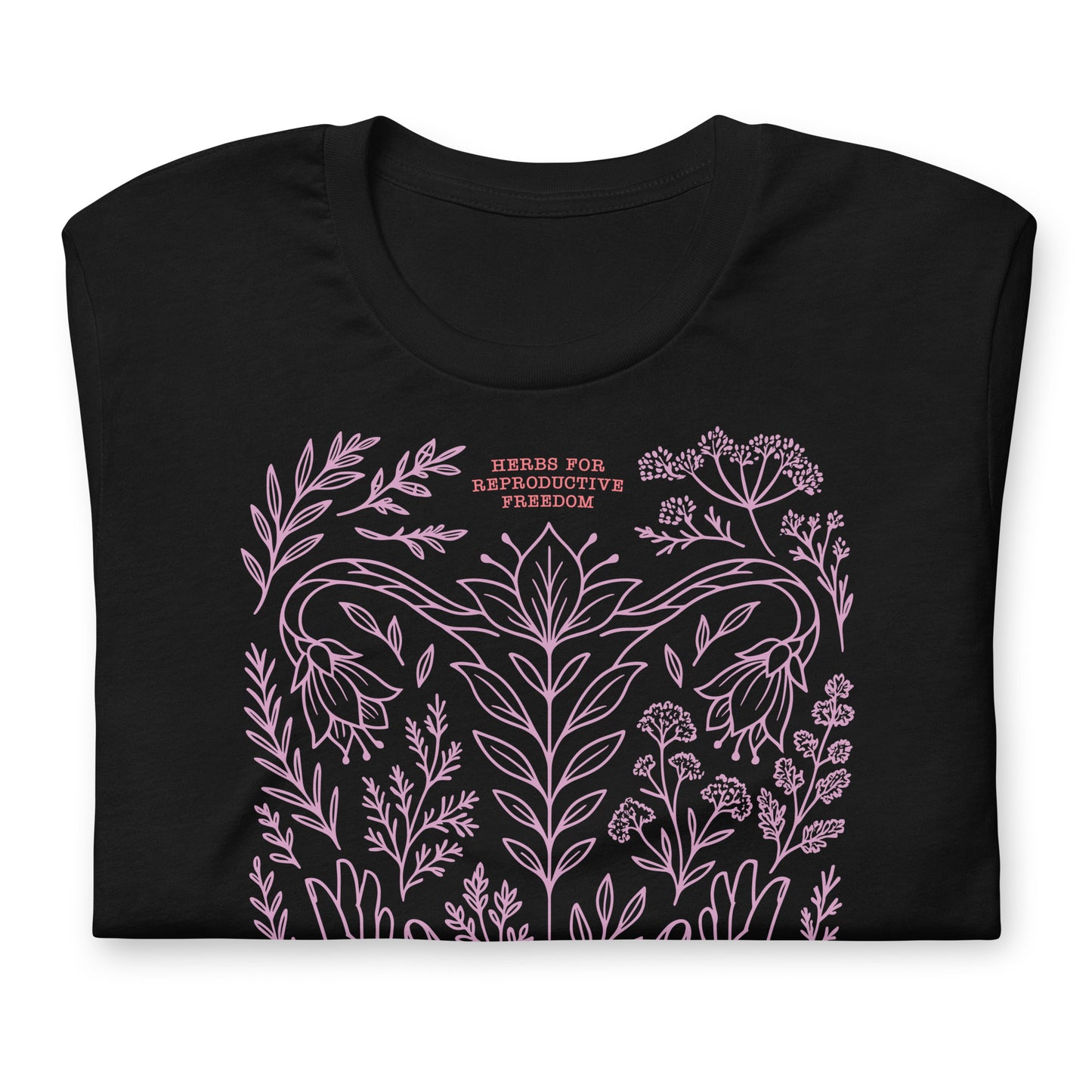 Close-up of the black herbal freedom t-shirt showing fine pink line art of herbs, flowers, and the crescent moon symbolizing care and resistance.
