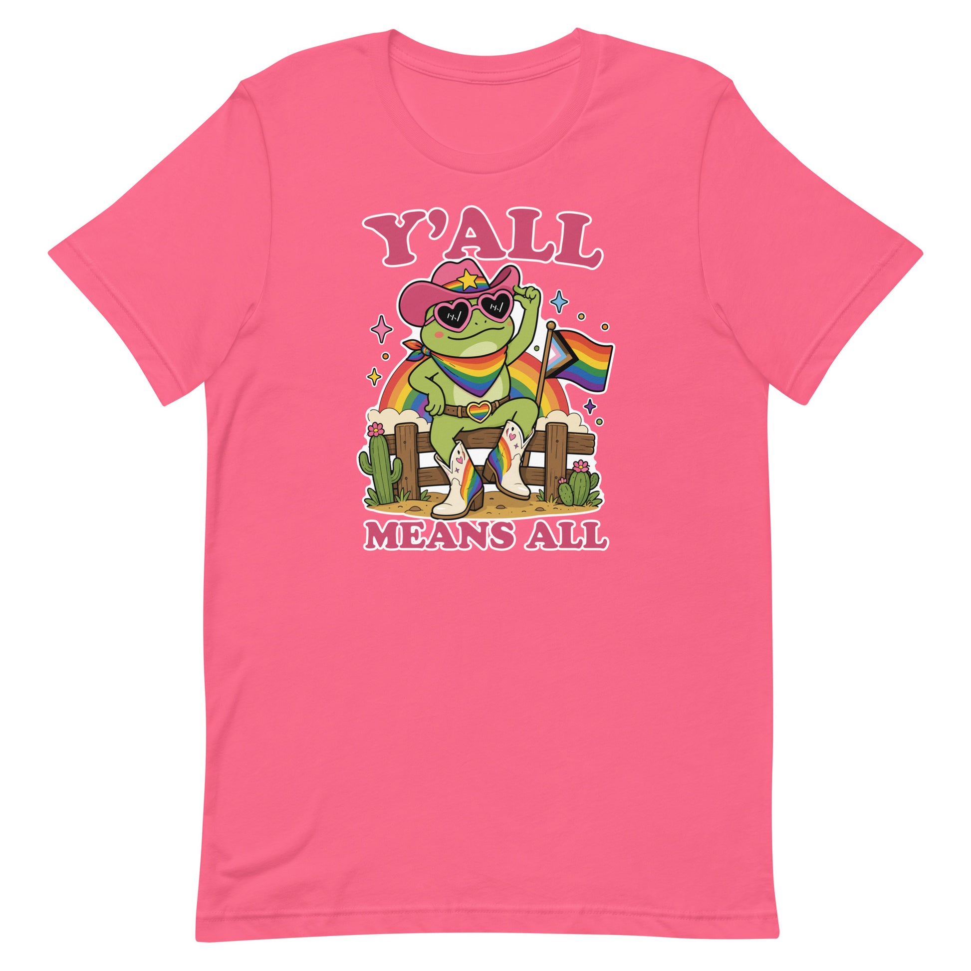 Pink unisex pride t-shirt featuring colorful cowboy frog artwork with rainbow flag accents and “Y’All Means All” message celebrating visibility and inclusion.