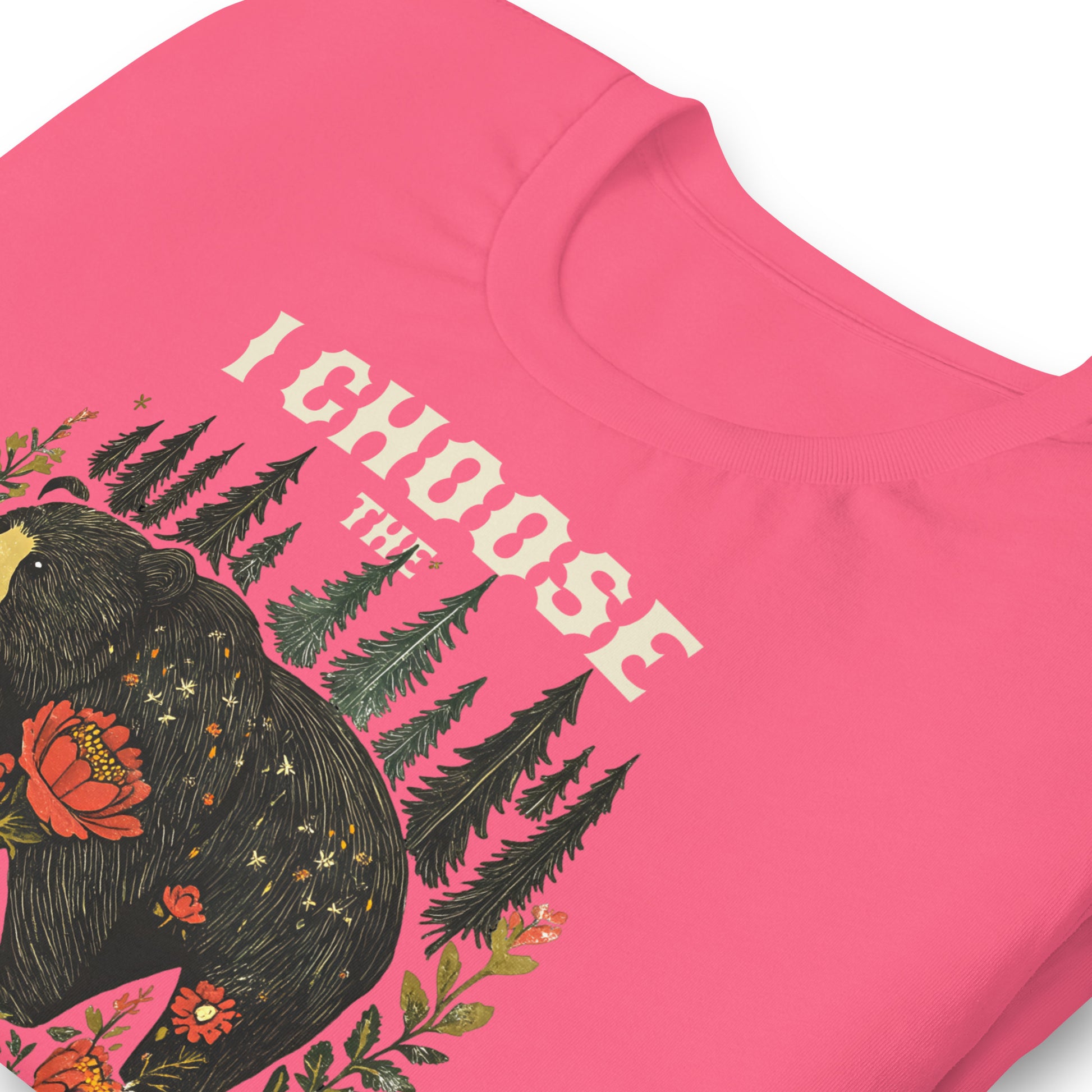 Close-up of pink unisex t-shirt featuring illustrated bear and floral forest artwork with phrase “I Choose The Bear,” feminist activist clothing.