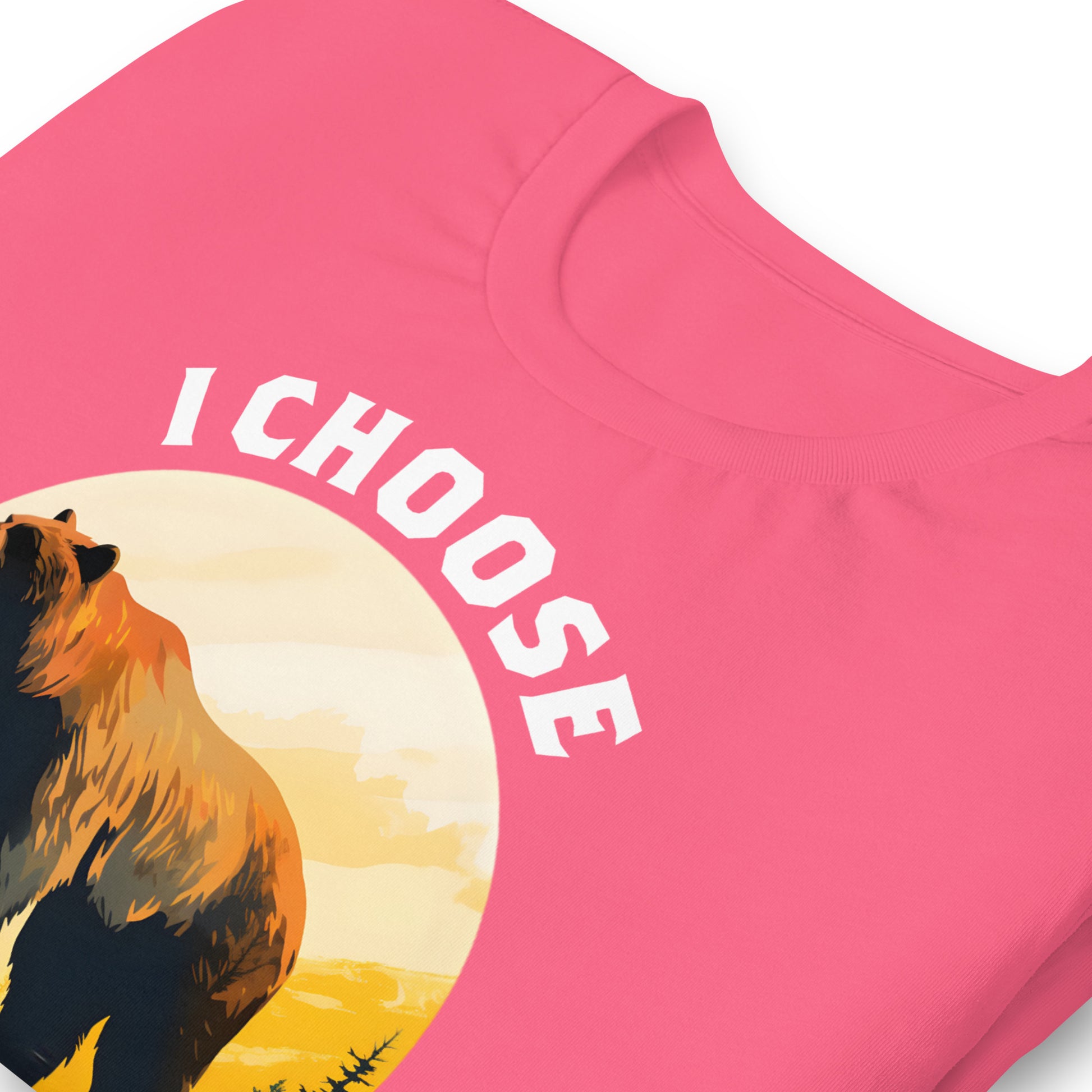 Close-up of heather pink unisex t-shirt featuring bear illustration in sunset circle with phrase “I Choose The Bear,” women empowerment activist clothing.