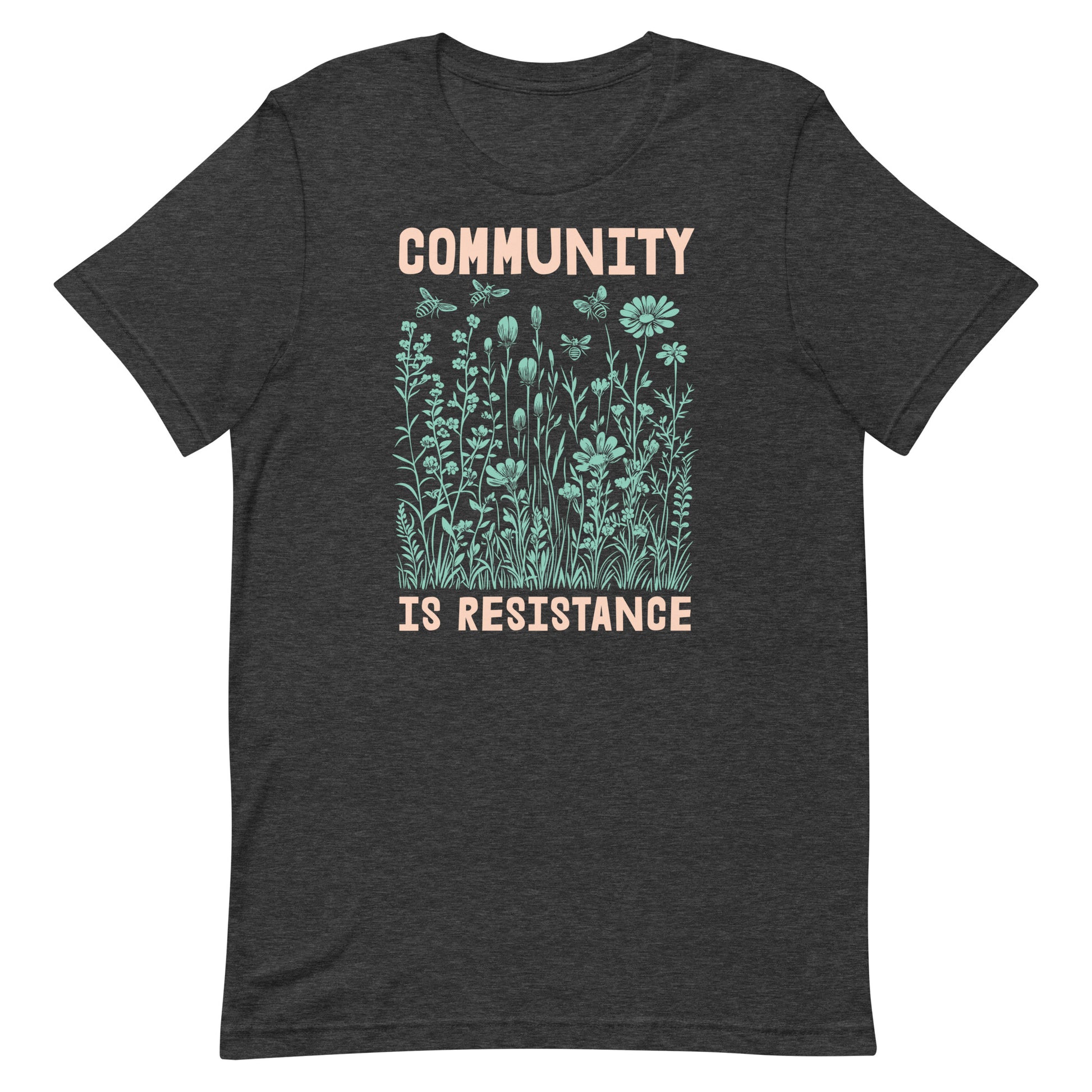 Dark heather gray Community Is Resistance t-shirt with mint-green floral artwork and peach lettering. A grounded, organic look for those who believe community is the heart of activism.