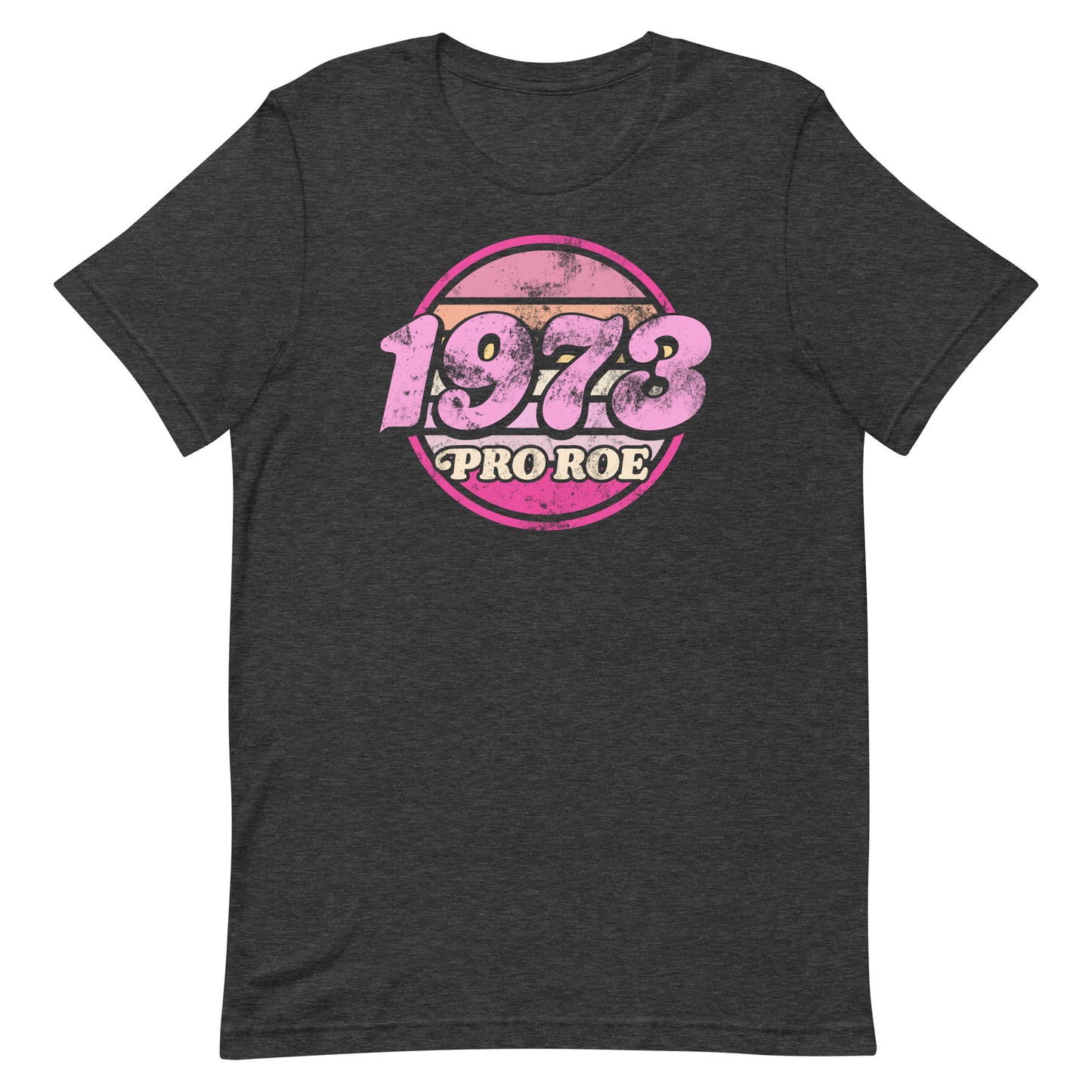 Dark charcoal gray unisex t-shirt featuring a distressed pink circular badge reading “1973 PRO ROE,” retro reproductive freedom graphic centered on heathered fabric from Blue Wave USA.