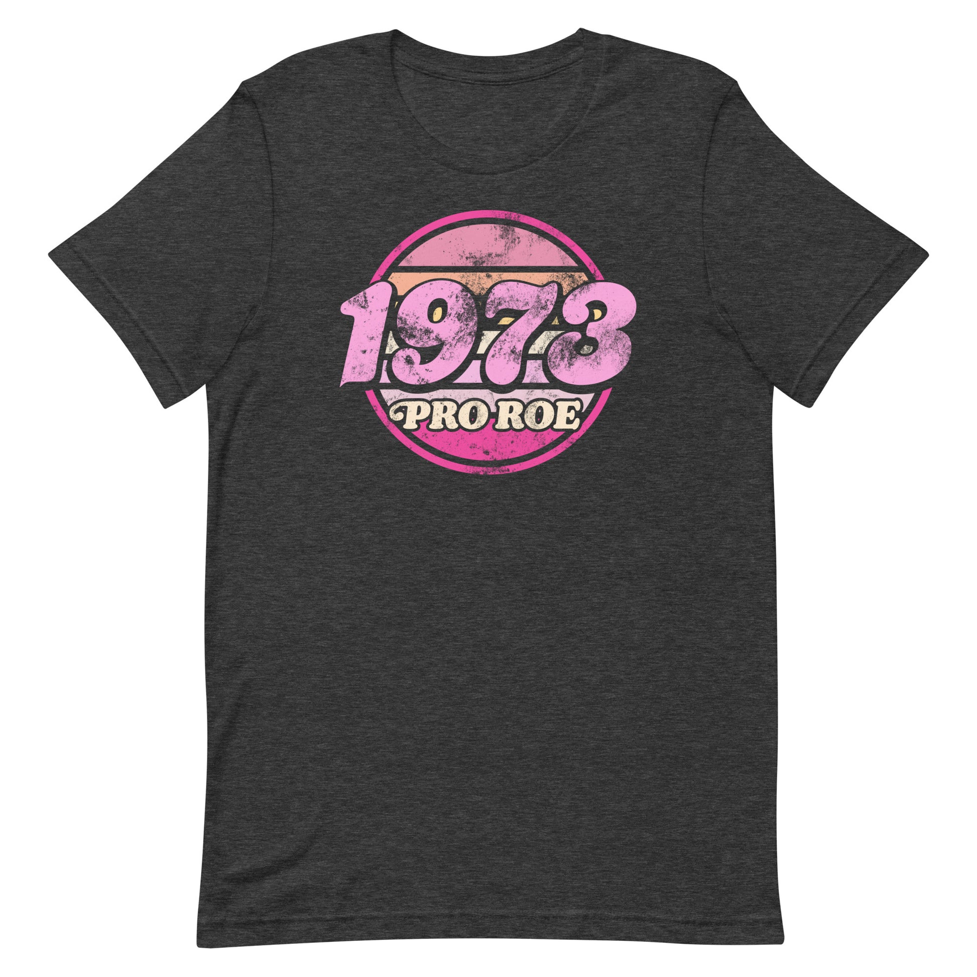 Dark charcoal gray unisex t-shirt featuring a distressed pink circular badge reading “1973 PRO ROE,” retro reproductive freedom graphic centered on heathered fabric from Blue Wave USA.