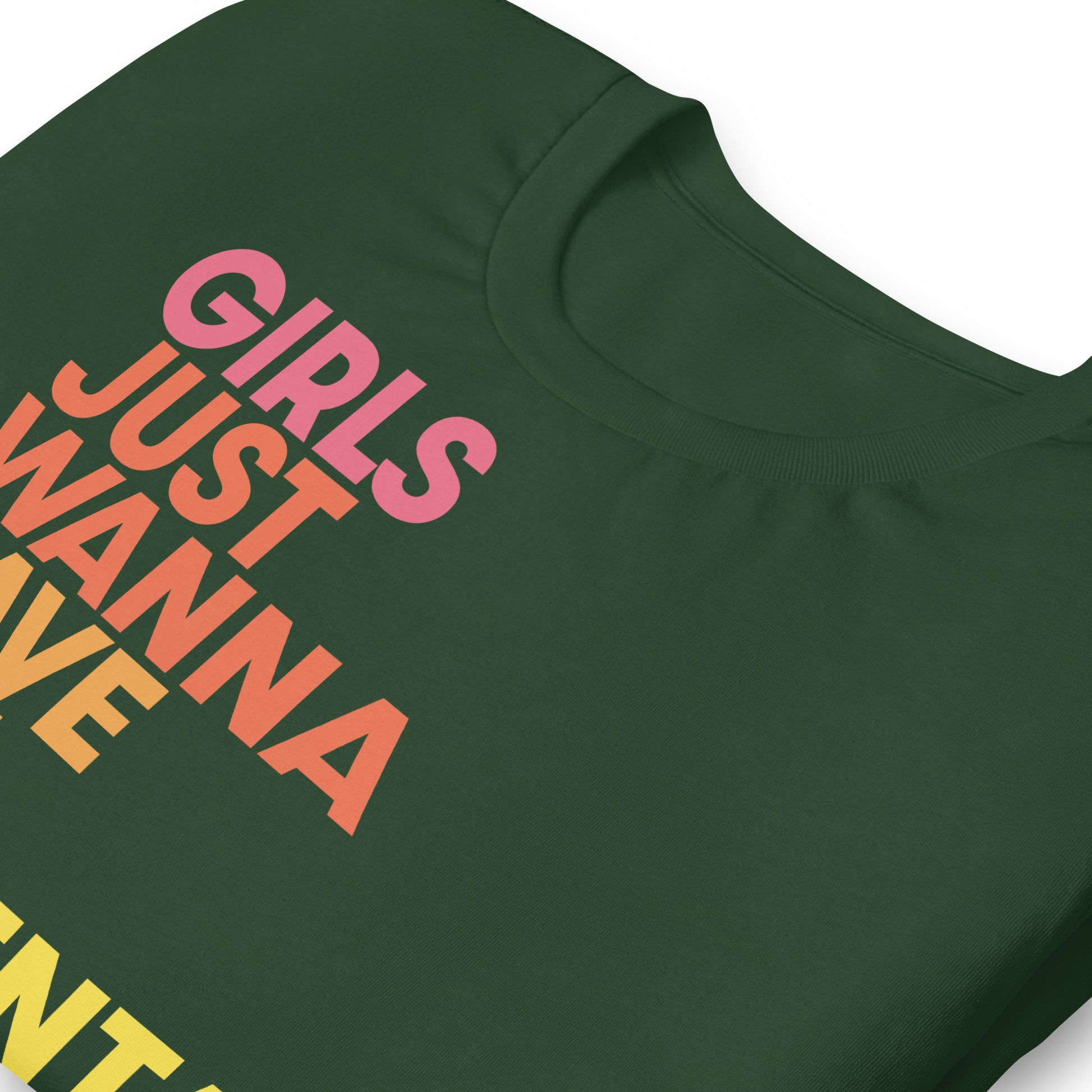 Close-up of green feminist t-shirt with bold yellow and pink lettering “Girls Just Wanna Have Fundamental Human Rights.”