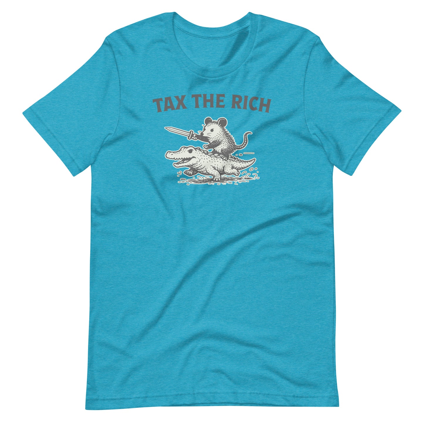Heather aqua blue t-shirt displaying a monochrome opossum riding an alligator graphic with “Tax the Rich” slogan combining political humor and economic justice themes.