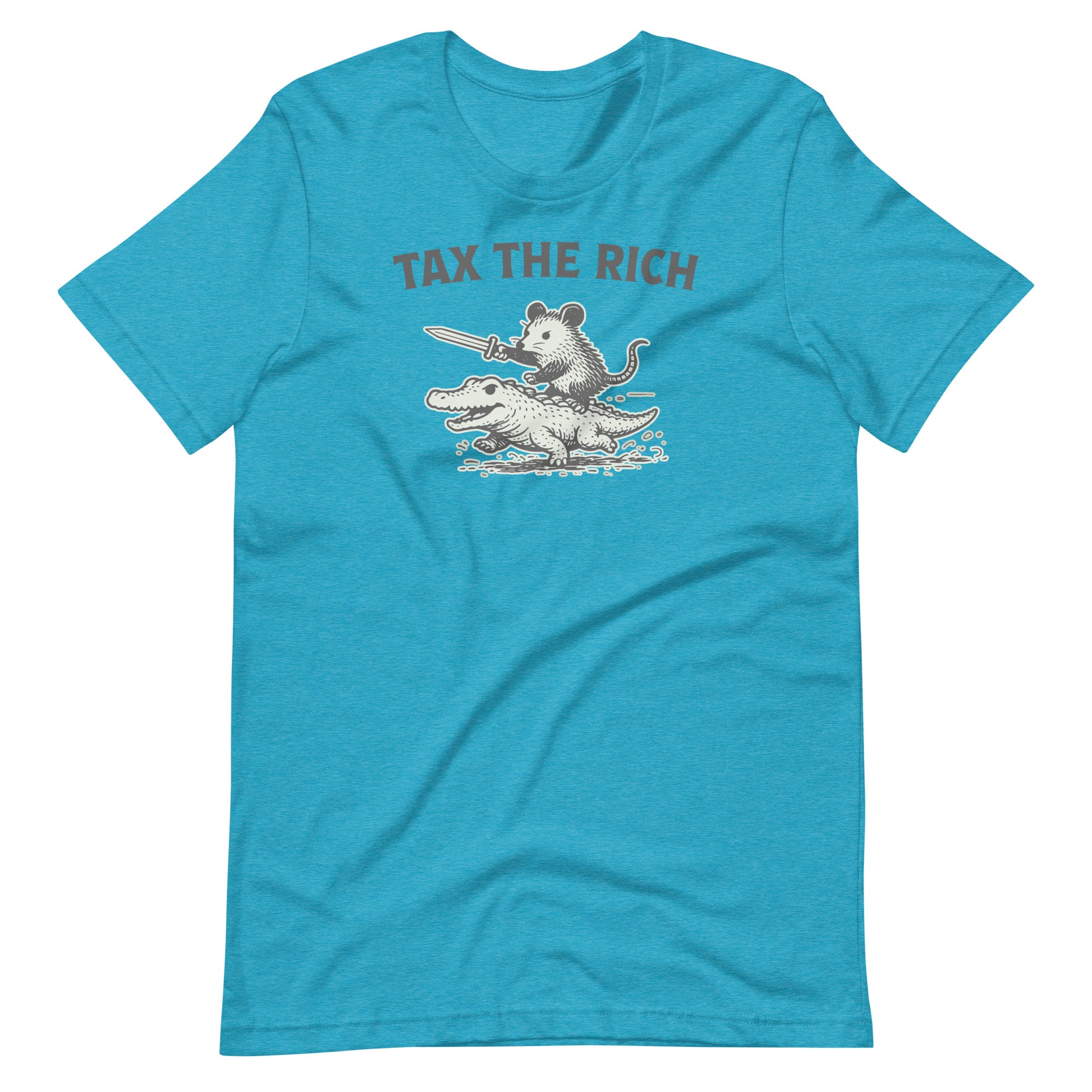 Heather aqua blue t-shirt displaying a monochrome opossum riding an alligator graphic with “Tax the Rich” slogan combining political humor and economic justice themes.