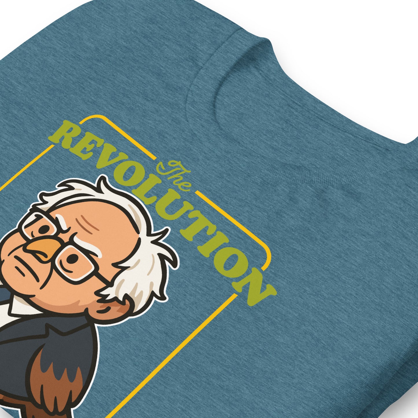 Close-up blue heather unisex tee print showing Birdie Sanders illustration with vintage-style “Revolution” typography and tweeted slogan detail.