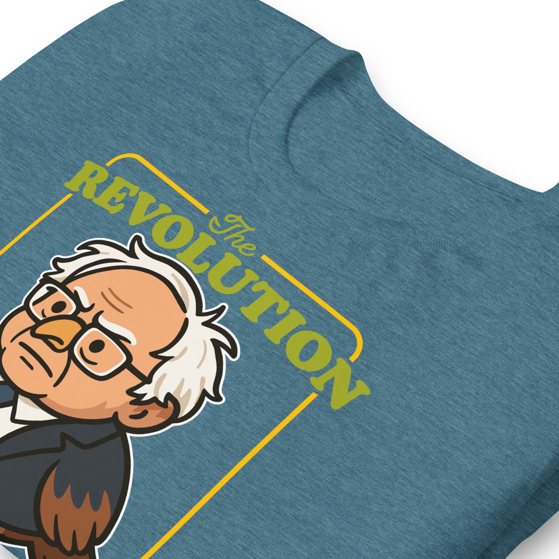 Close-up blue heather unisex tee print showing Birdie Sanders illustration with vintage-style “Revolution” typography and tweeted slogan detail.