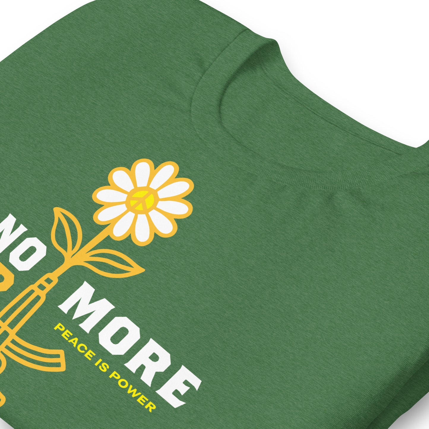 Close-up of heather grass green unisex tee artwork showing rifle transforming into yellow flower with “No More War” lettering and “Peace Is Power” detail.