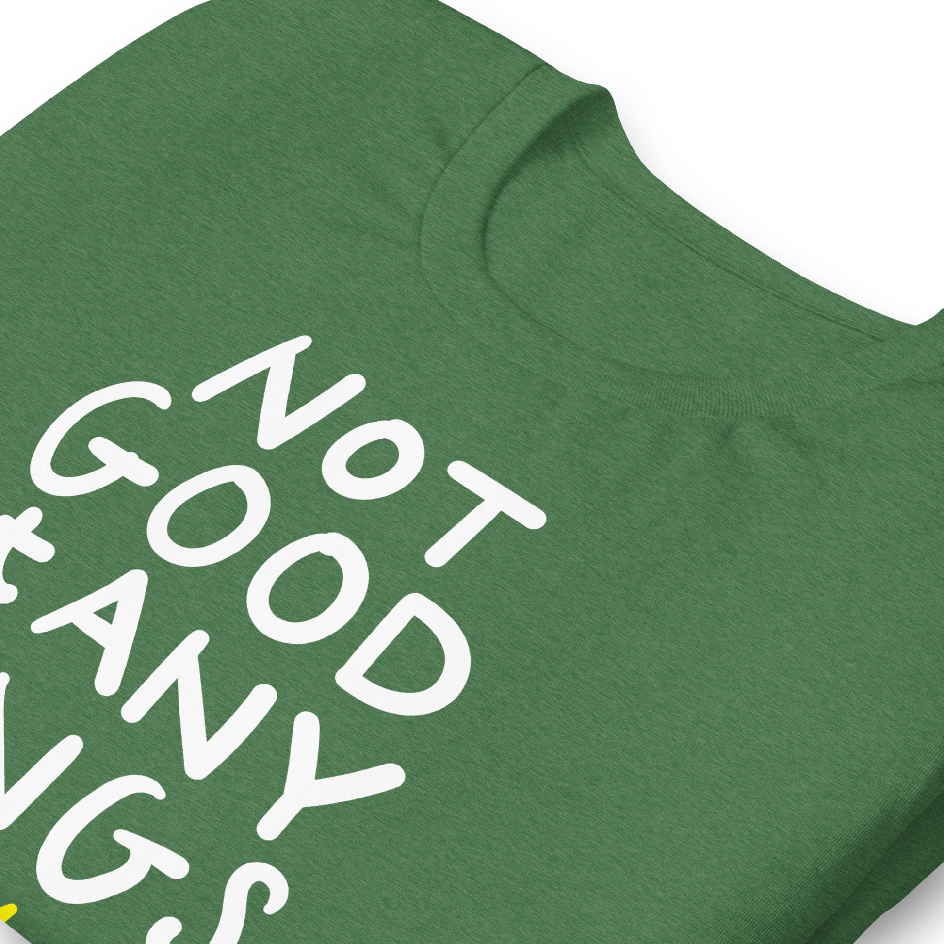 Close view of heather green t-shirt fabric showing hand-drawn text “NOT GOOD AT ANY KINGS” and crossed crown illustration.