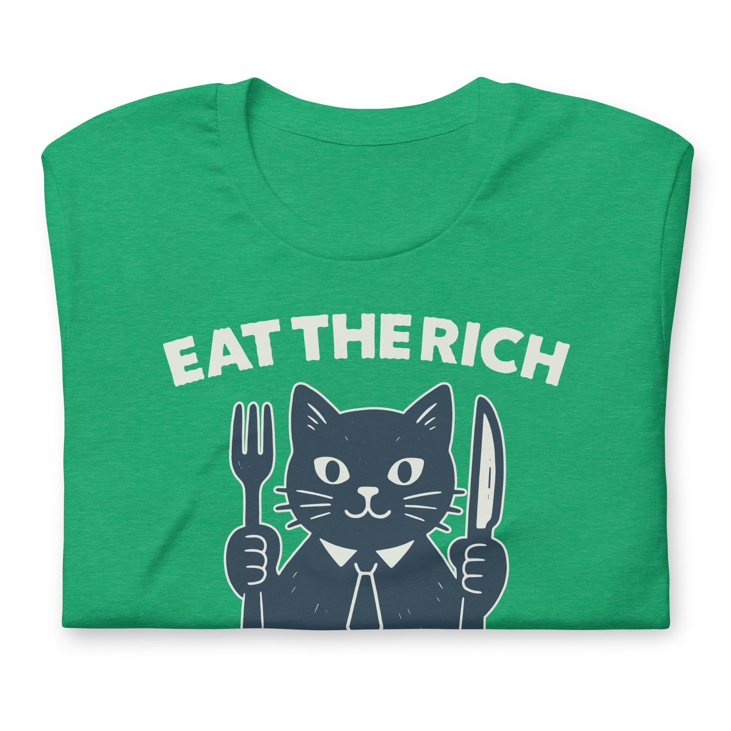 Folded heather kelly green t-shirt displaying a playful cat illustration holding cutlery beneath the phrase “Eat the Rich,” combining political humor and protest-inspired design.