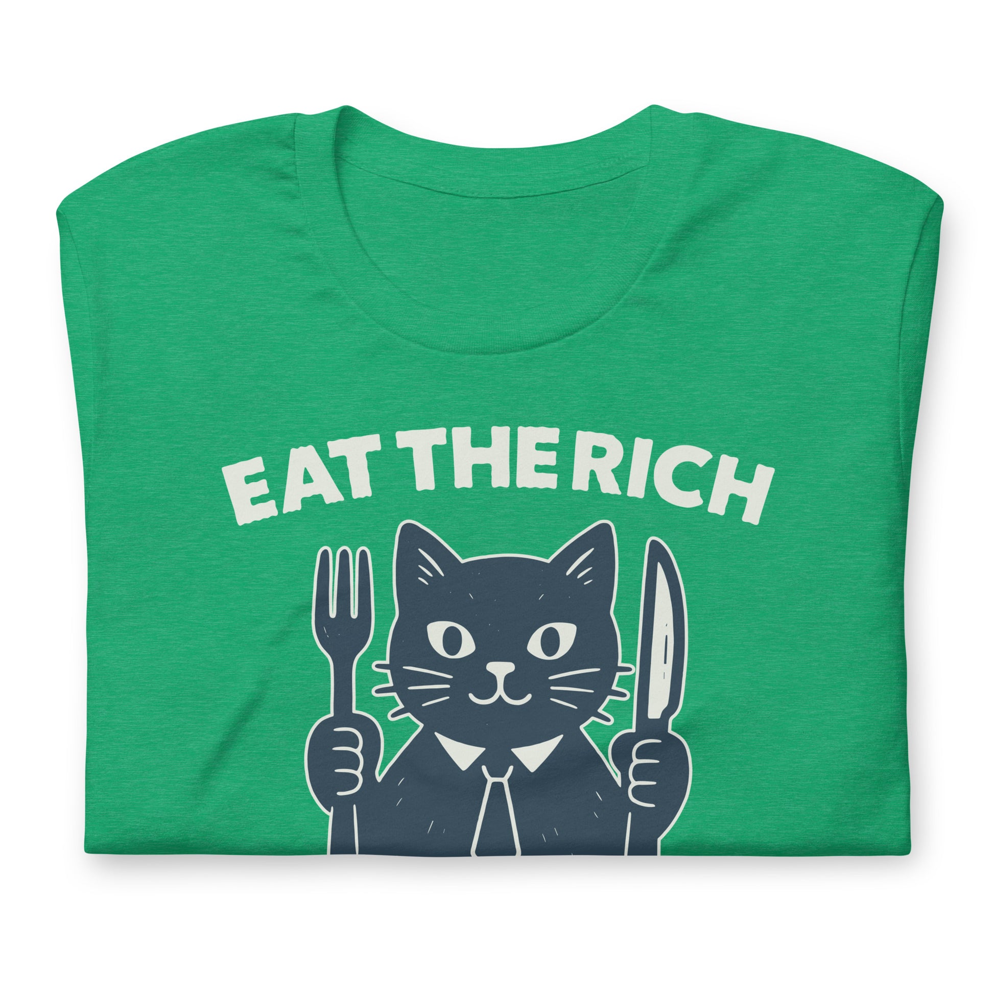 Folded heather kelly green t-shirt displaying a playful cat illustration holding cutlery beneath the phrase “Eat the Rich,” combining political humor and protest-inspired design.