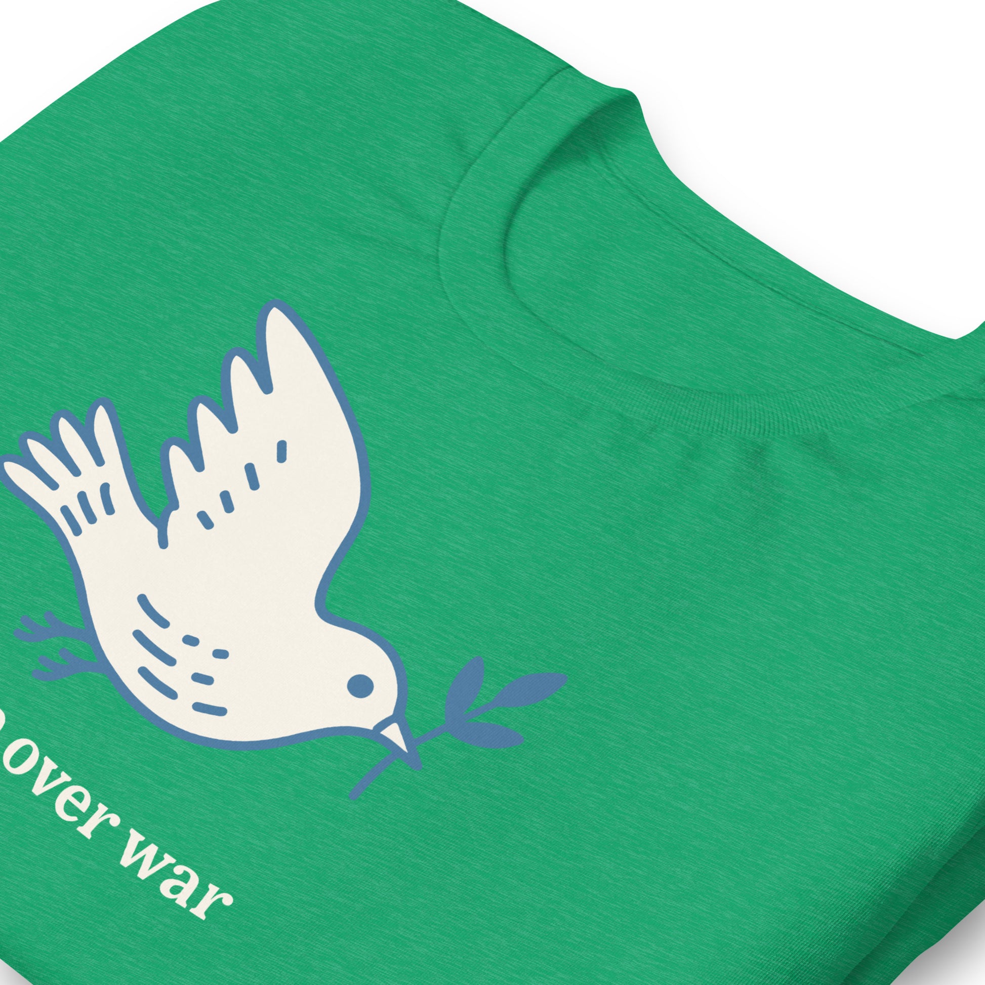 Close-up heather kelly green unisex T-shirt print showing white dove illustration, olive branch, and visible “peace over war” phrase in minimalist peace design.