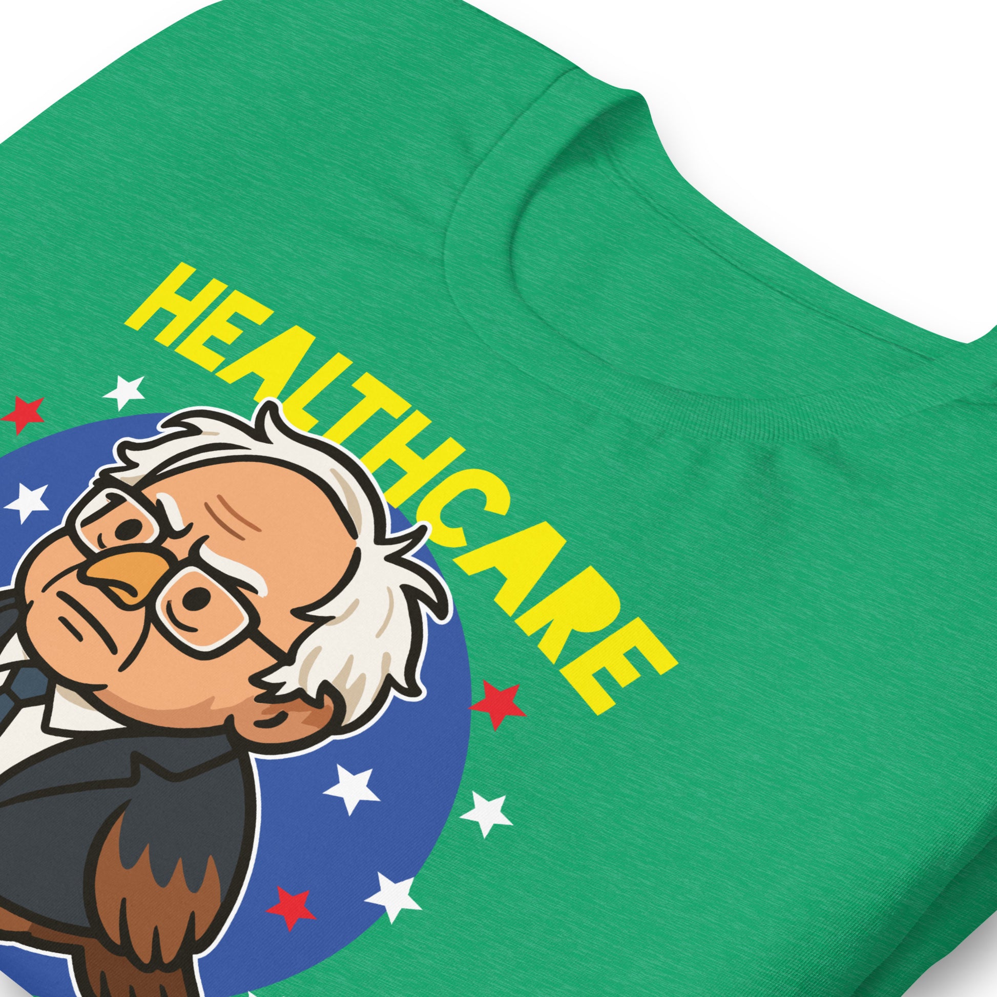 Close-up heather kelly green unisex T-shirt print showing Birdie Sanders healthcare parody artwork with “Healthcare for Every Birdie” slogan detail.