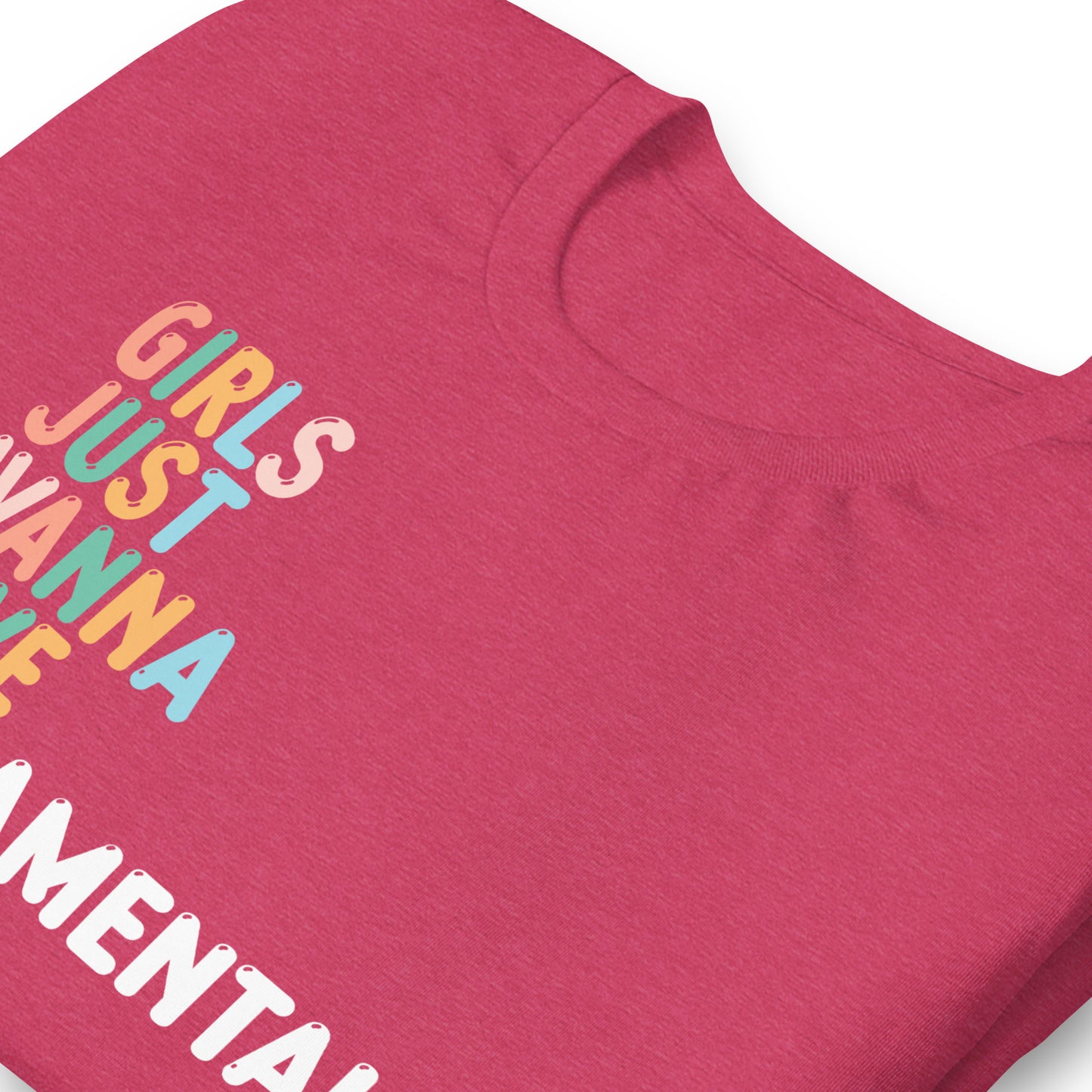Close-up of heather pink unisex t-shirt showing retro stacked typography reading “GIRLS JUST WANNA HAVE FUNDAMENTAL HUMAN RIGHTS,” feminist equality activist clothing.
