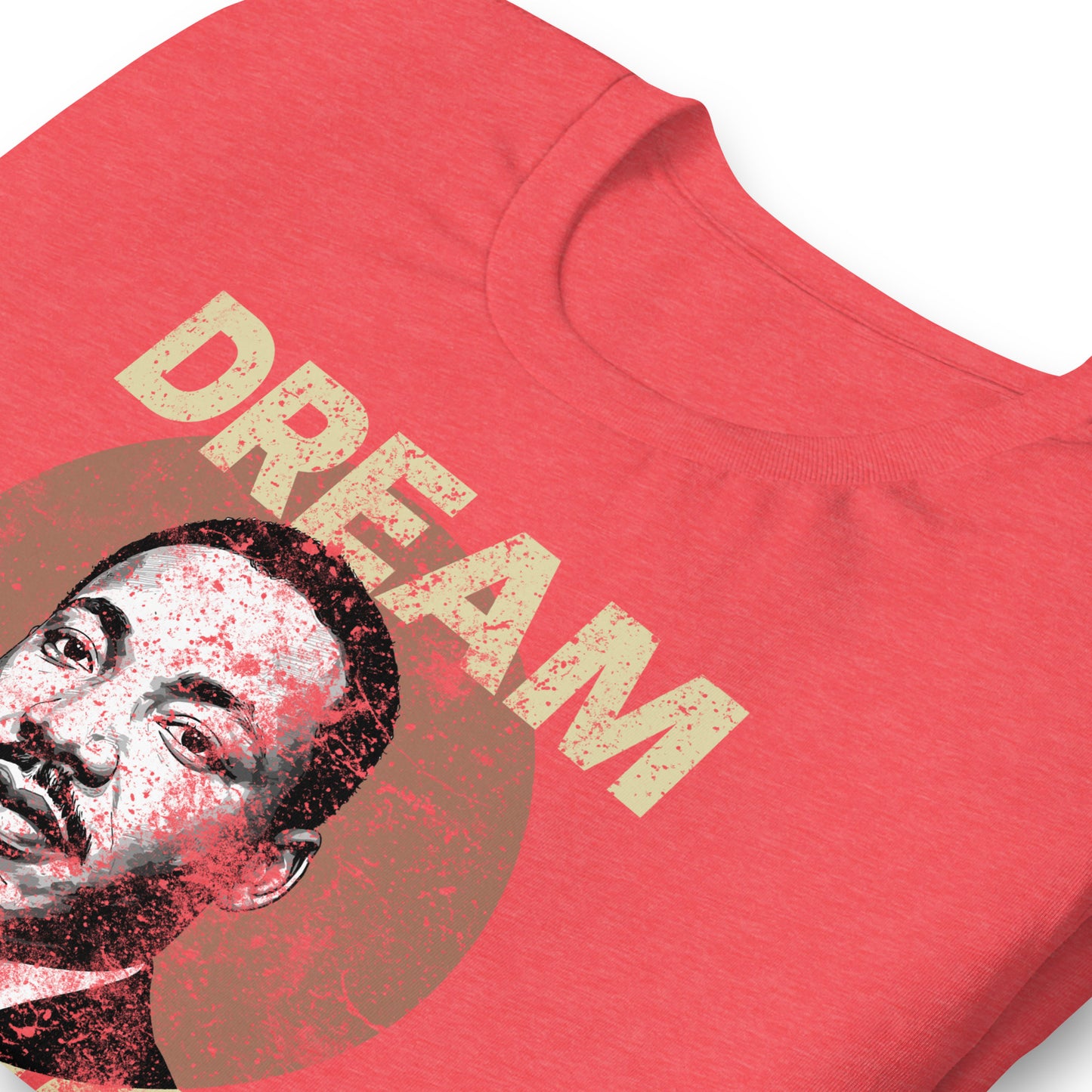 Close-up of red unisex t-shirt showing the distressed “DREAM LIKE KING” text and MLK portrait printed inside a textured circle. Vintage activist graphic from Blue Wave USA.