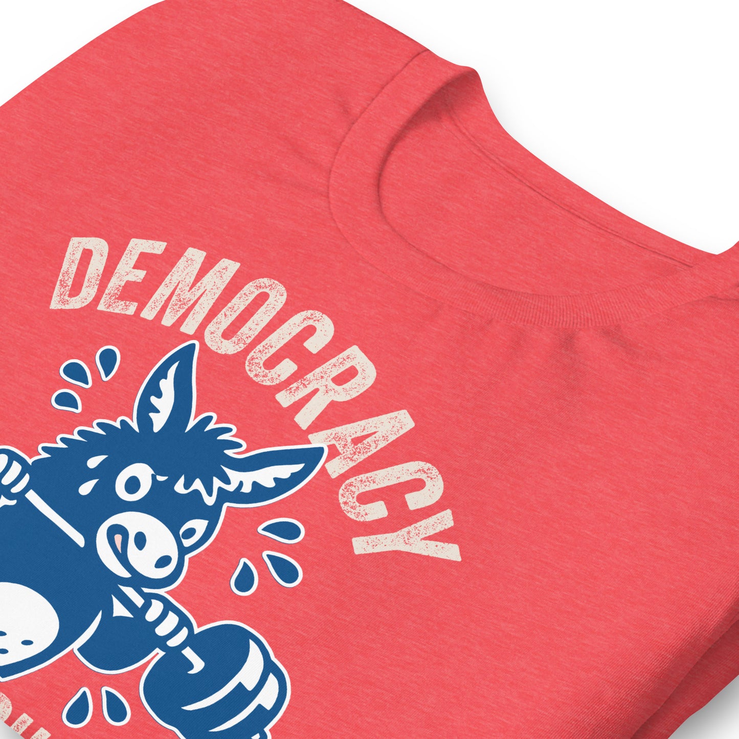 Close-up of heather red unisex T-shirt print showing blue donkey barbell artwork with curved democracy text and “Keeps You in Shape” wording.