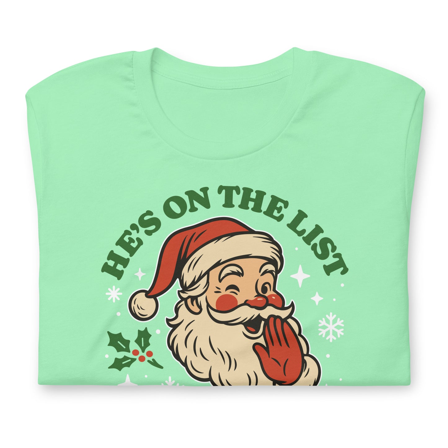 Mint green t-shirt featuring Santa’s silly expression and the “He’s On the List and It’s Not Mine” text, styled with a soft pastel winter vibe.